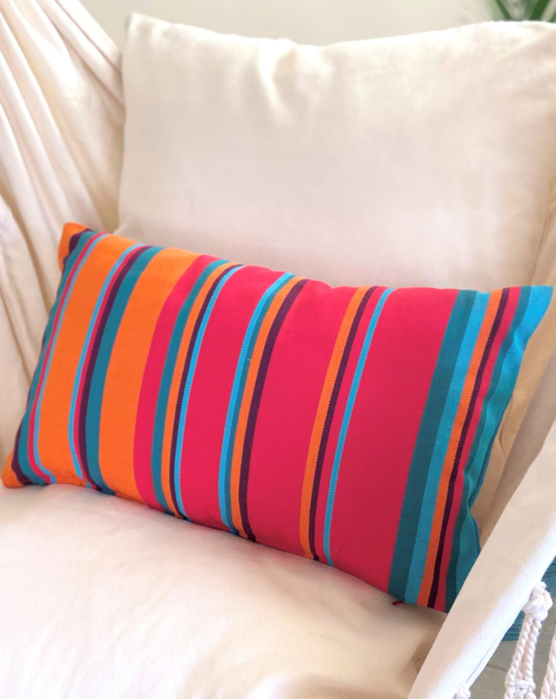 Colorful striped pillow on a beige sofa