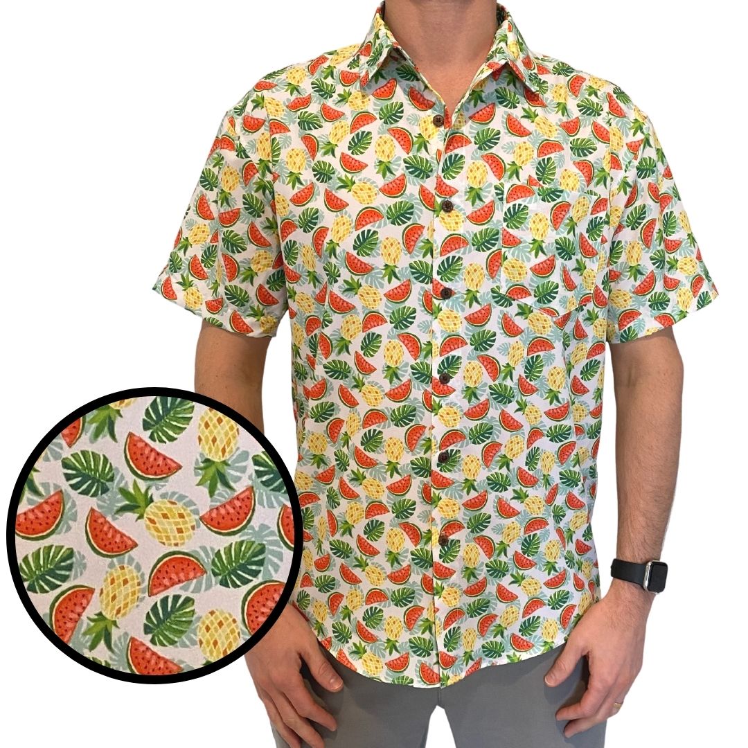 Man wearing a colorful shirt with fruit pattern, close-up of pattern shown.