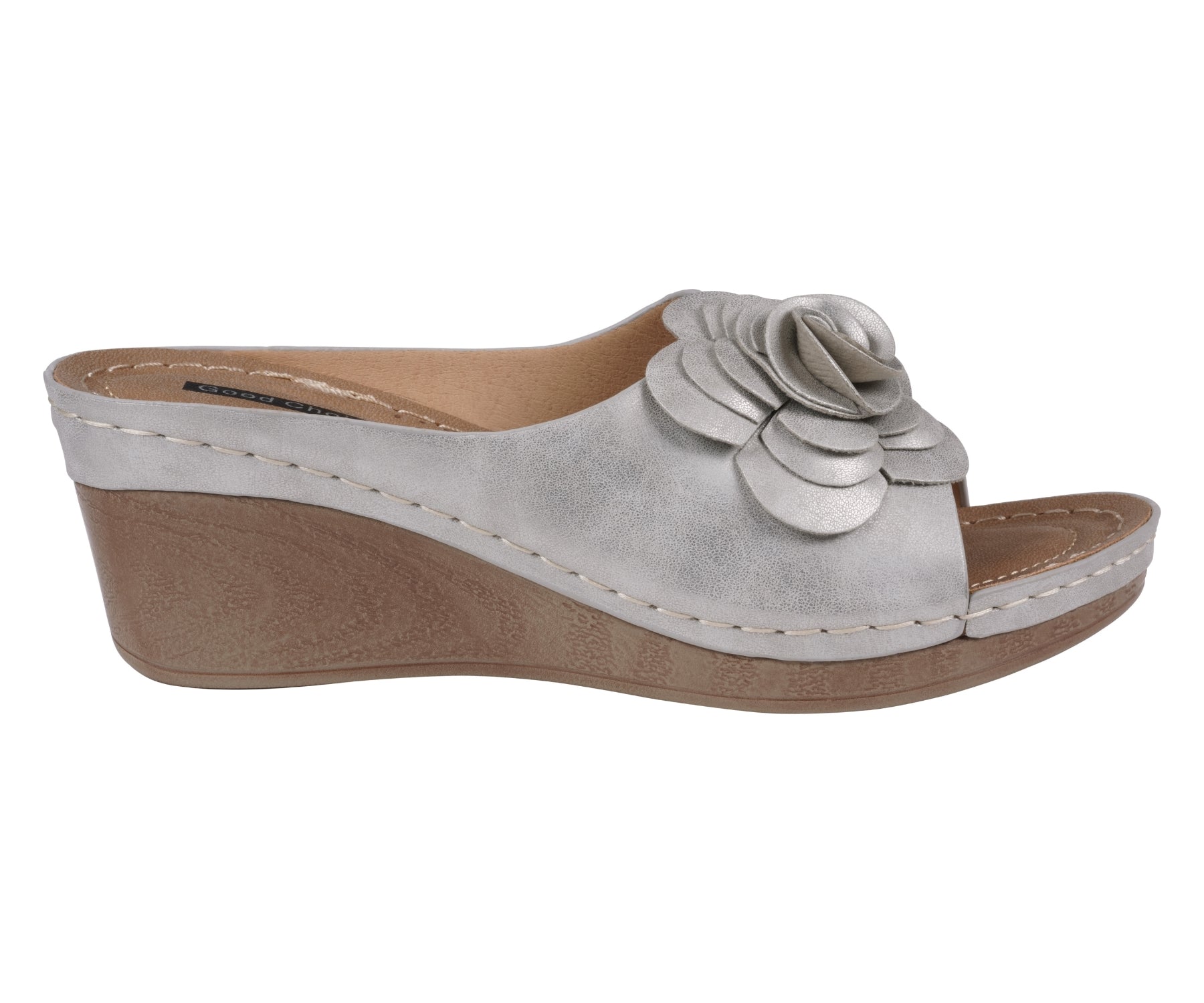 Silver wedge sandal with a floral design on a white background