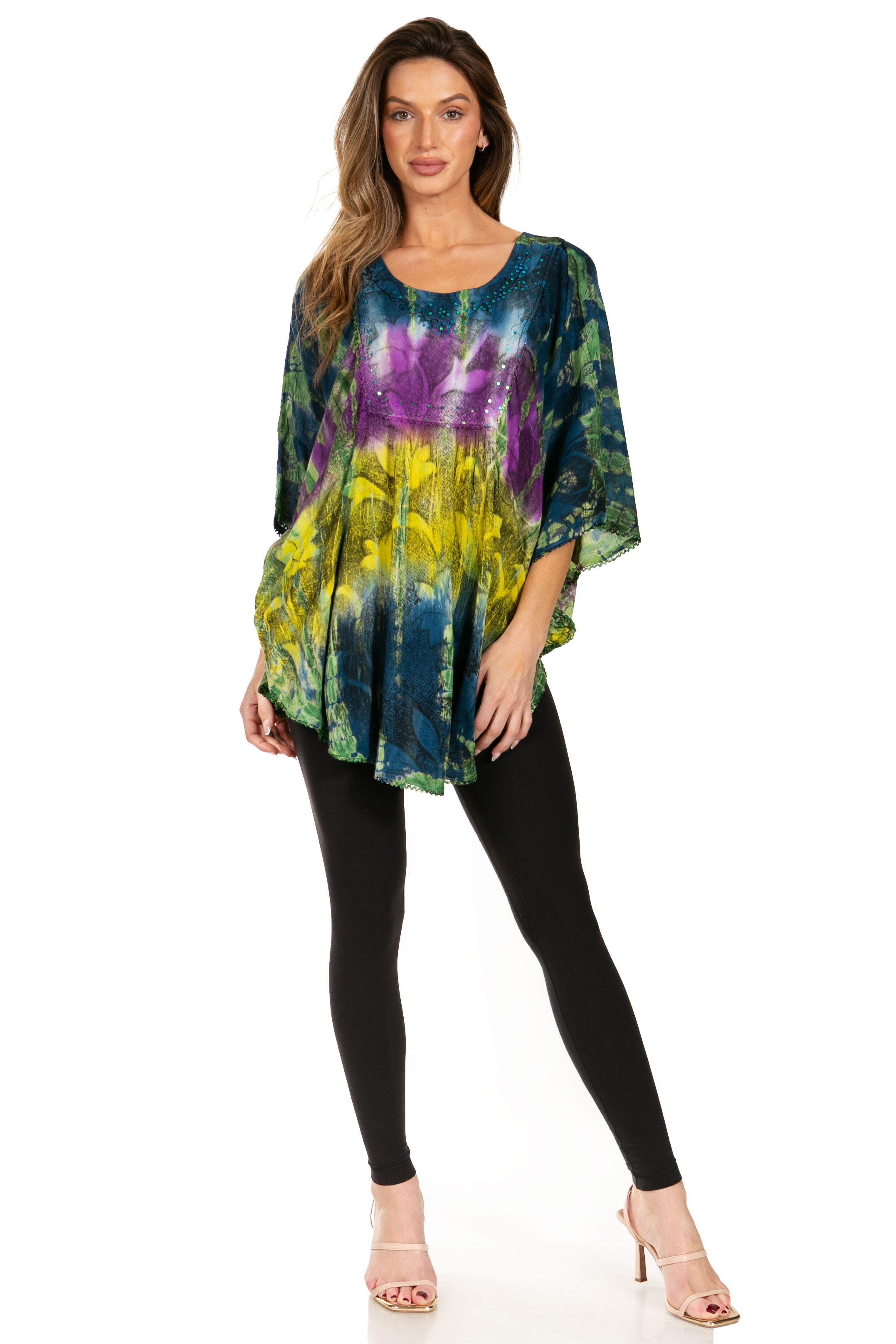 Woman wearing a colorful tie-dye dress with black leggings on a white background
