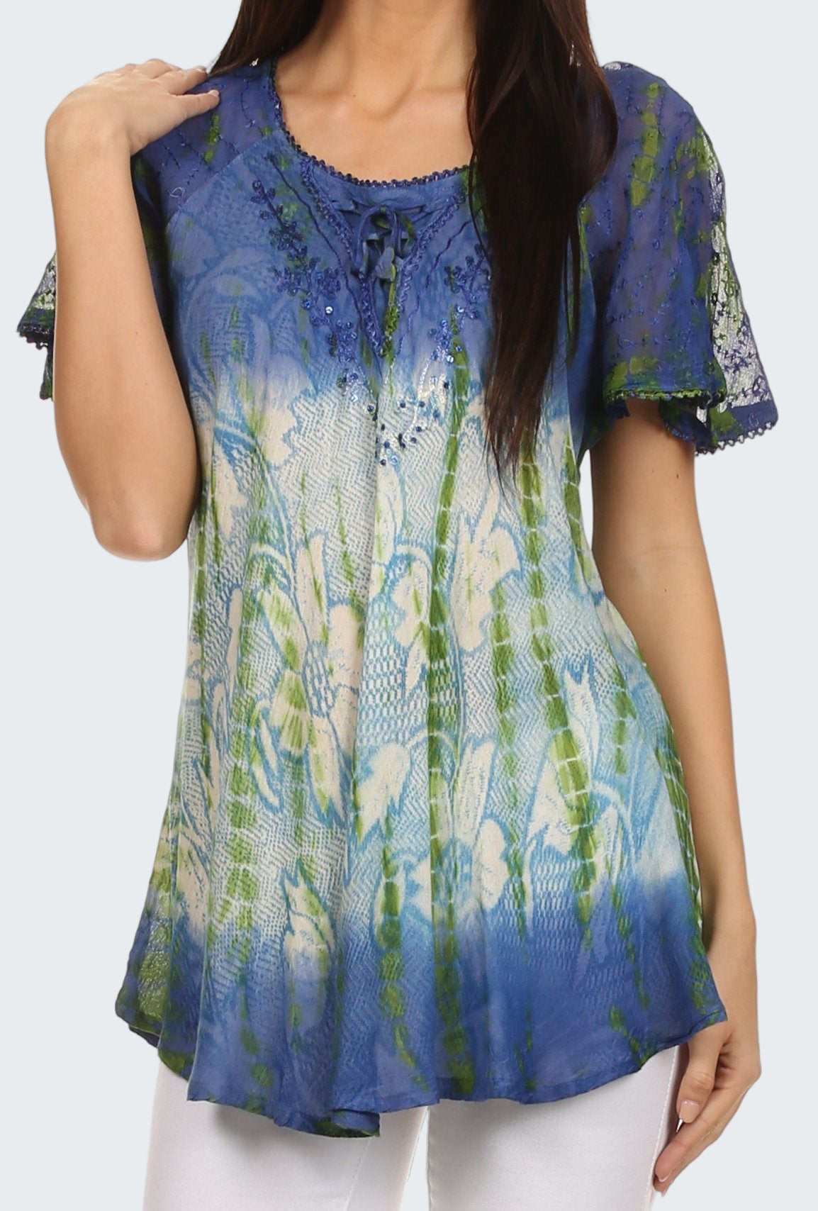 Woman wearing a colorful patterned top with short sleeves on a white background