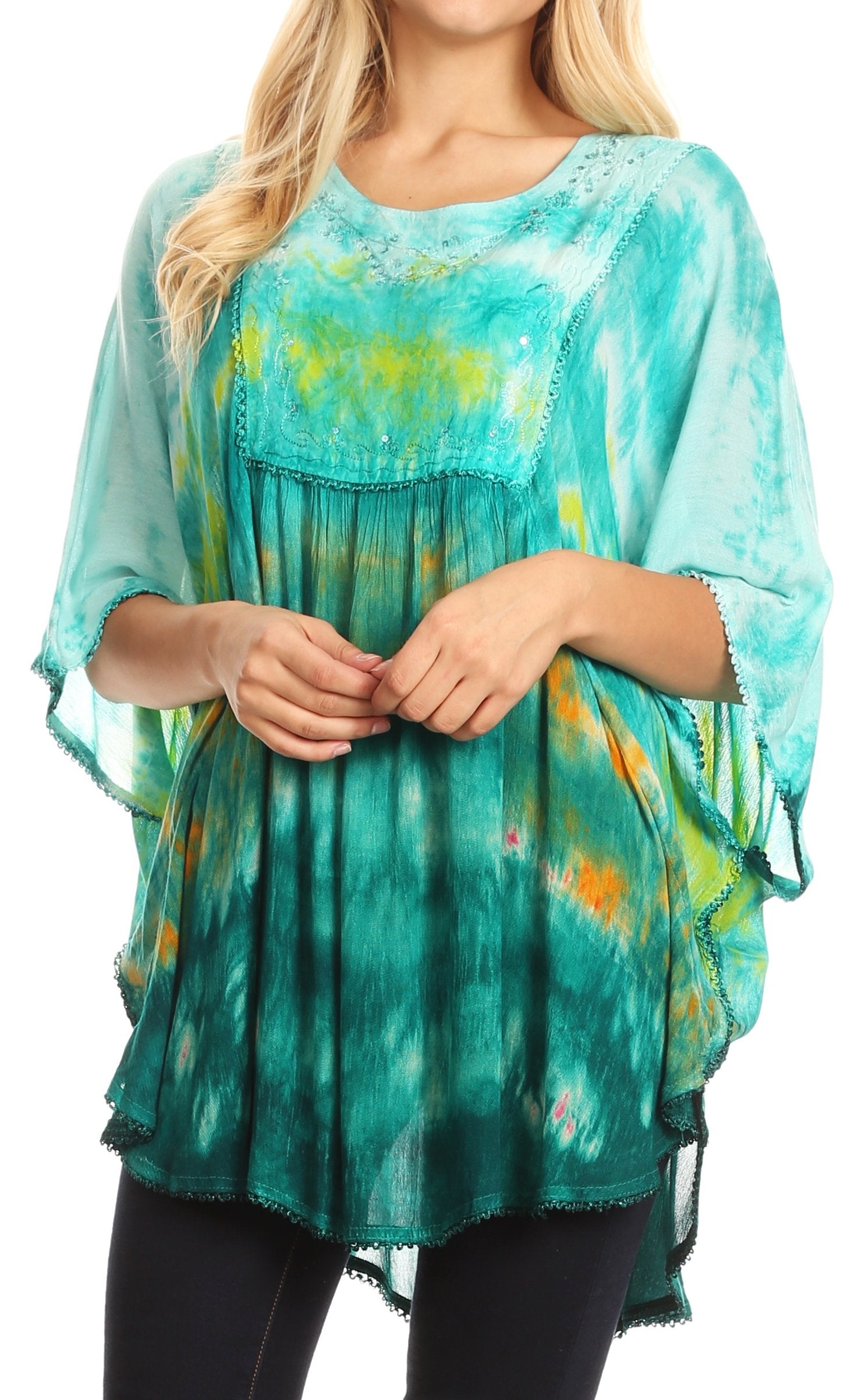Woman wearing a teal tie-dye blouse with a white background
