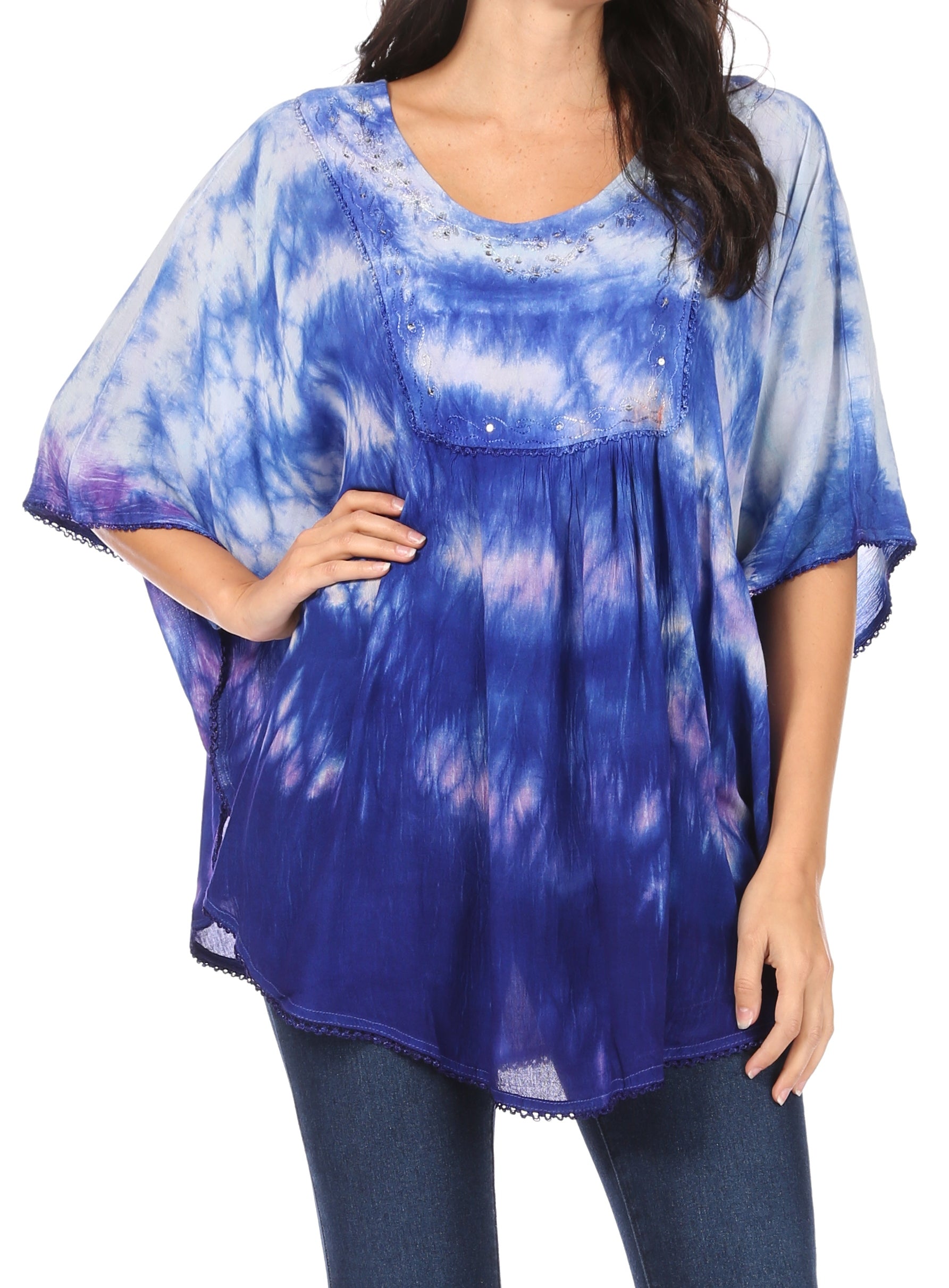 Woman wearing a blue tie-dye top with a white background