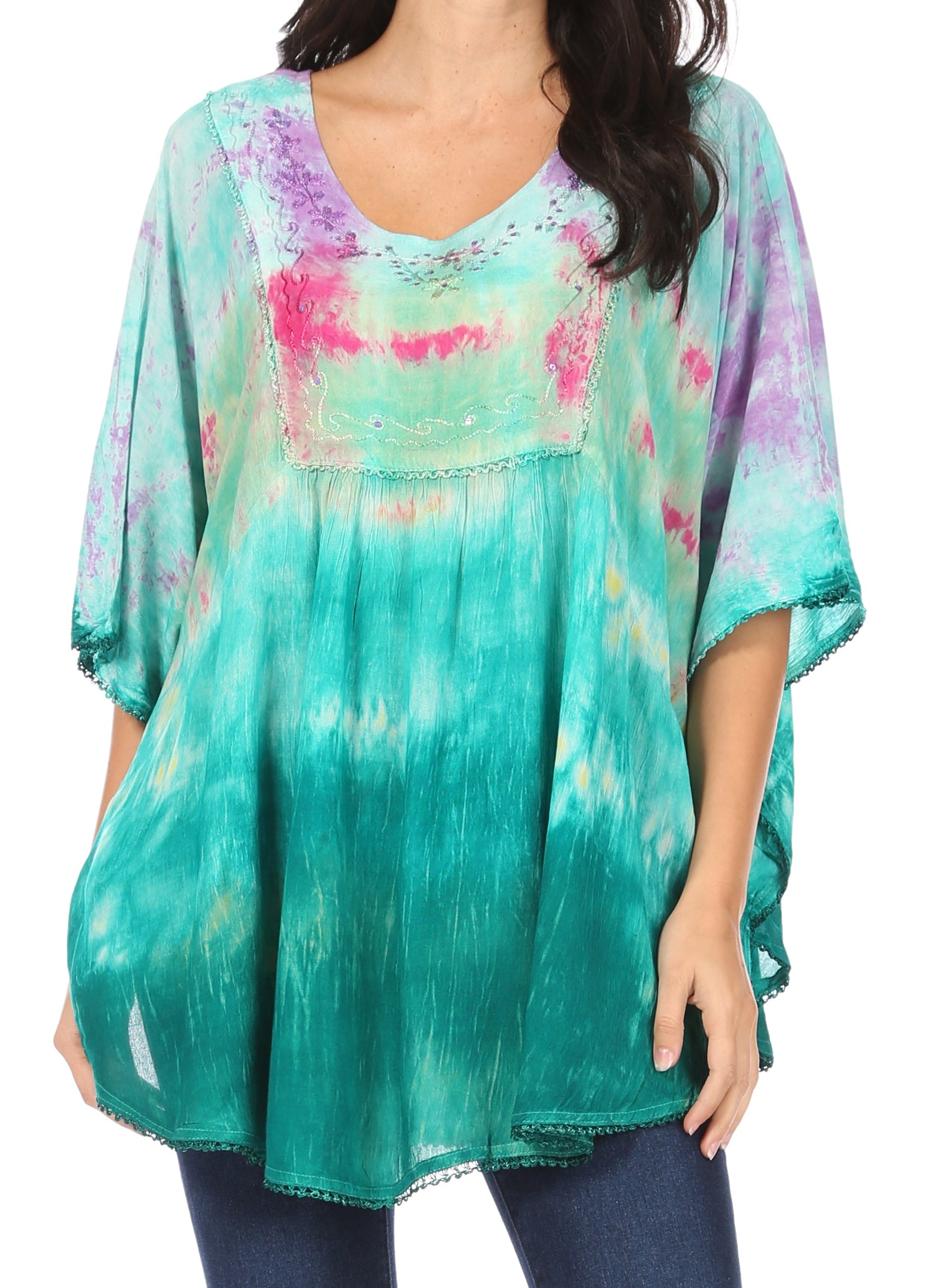 Woman wearing a colorful tie-dye top with a white background