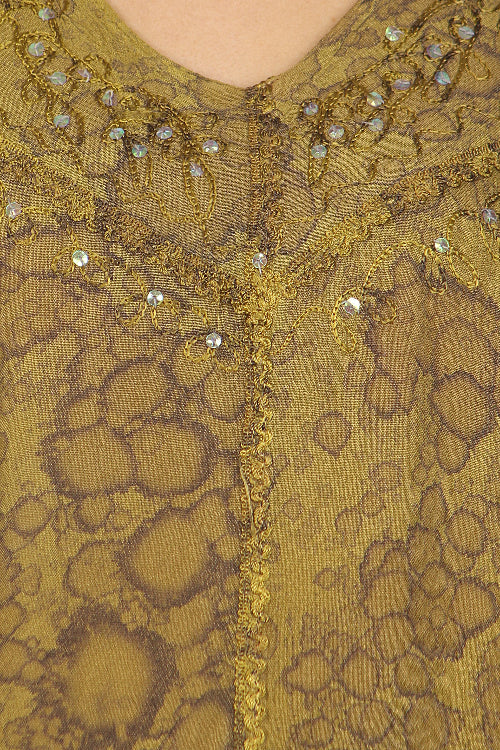 Close-up of a green embroidered garment with intricate patterns