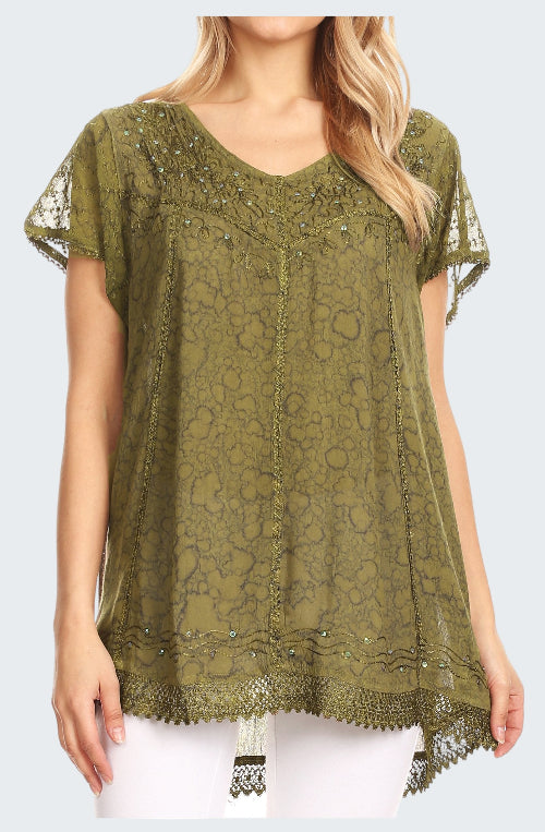 Green lace top with embellishments worn by a model on a white background