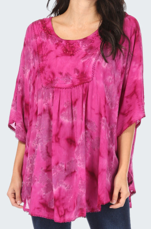 Pink tie-dye top worn by a person on a white background