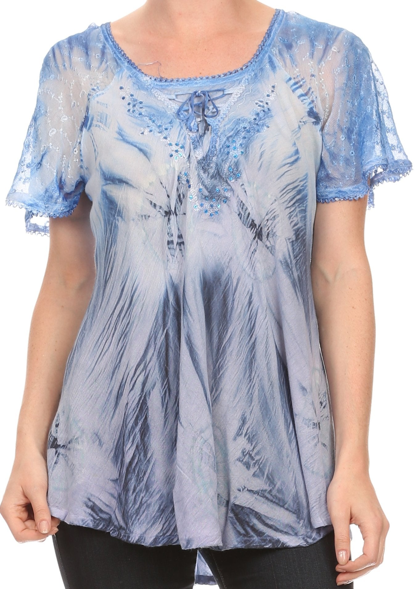 Blue and white tie-dye top worn by a person on a plain background