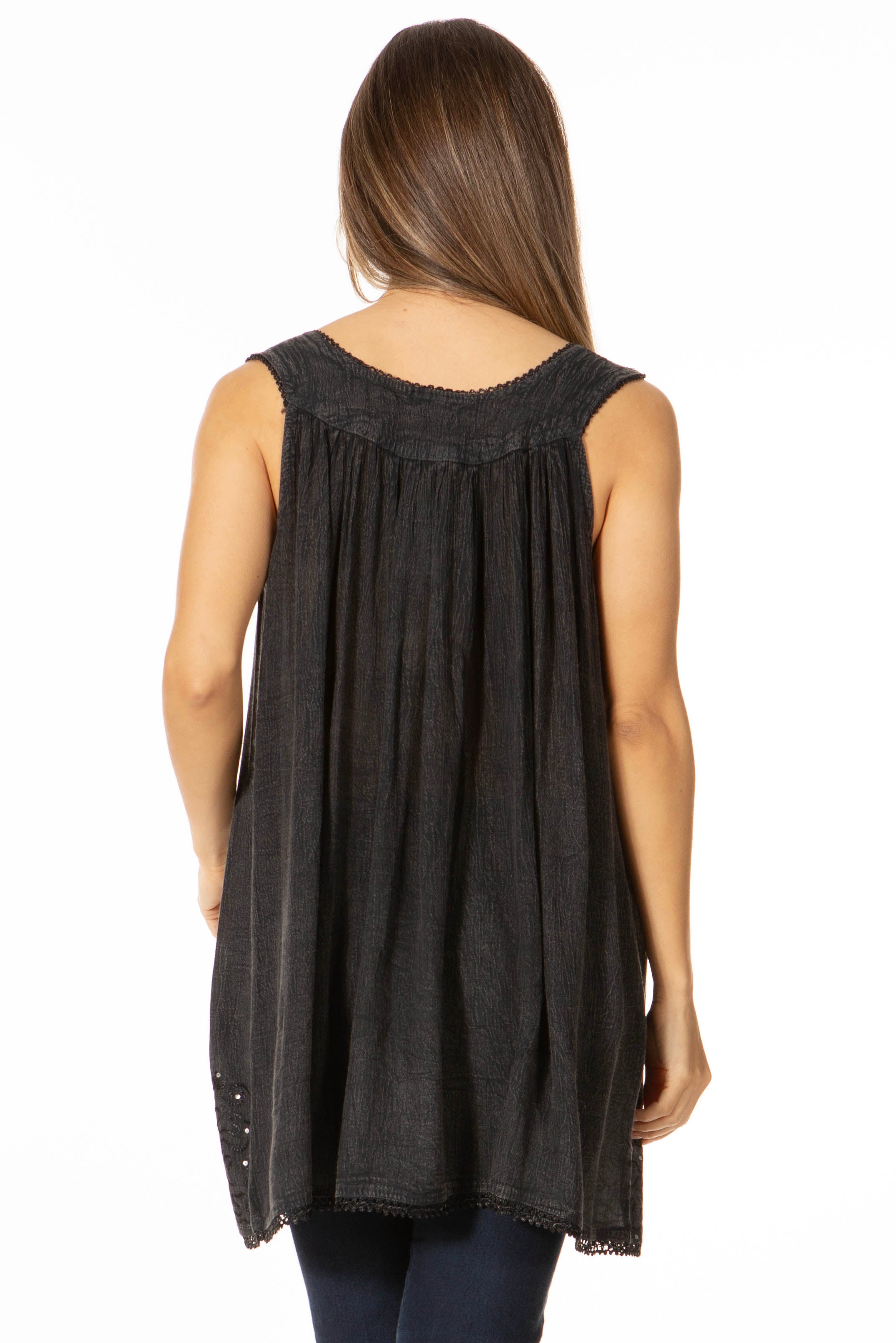 Black sleeveless top worn by a person on a white background