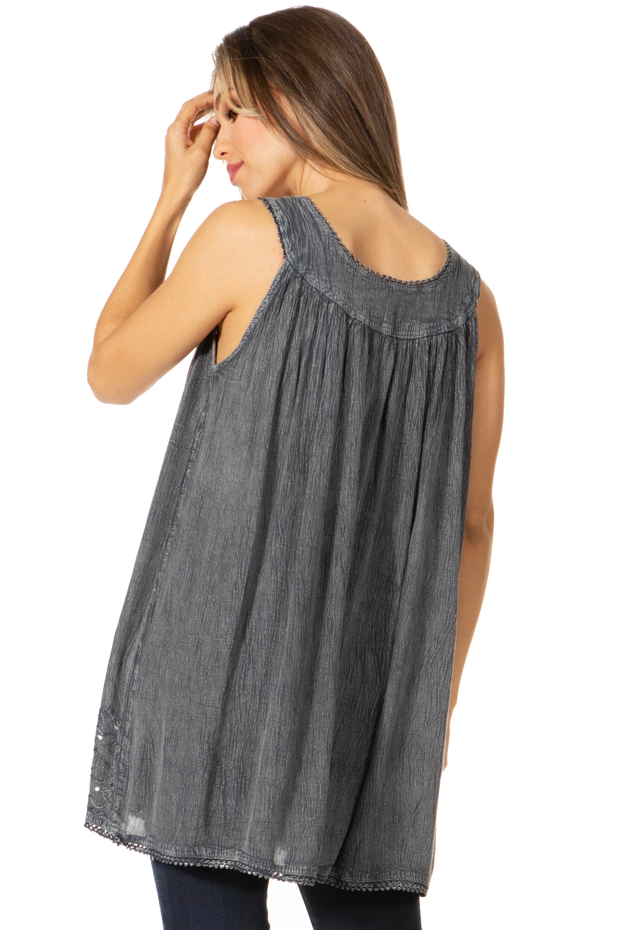 Woman wearing a gray sleeveless top on a white background