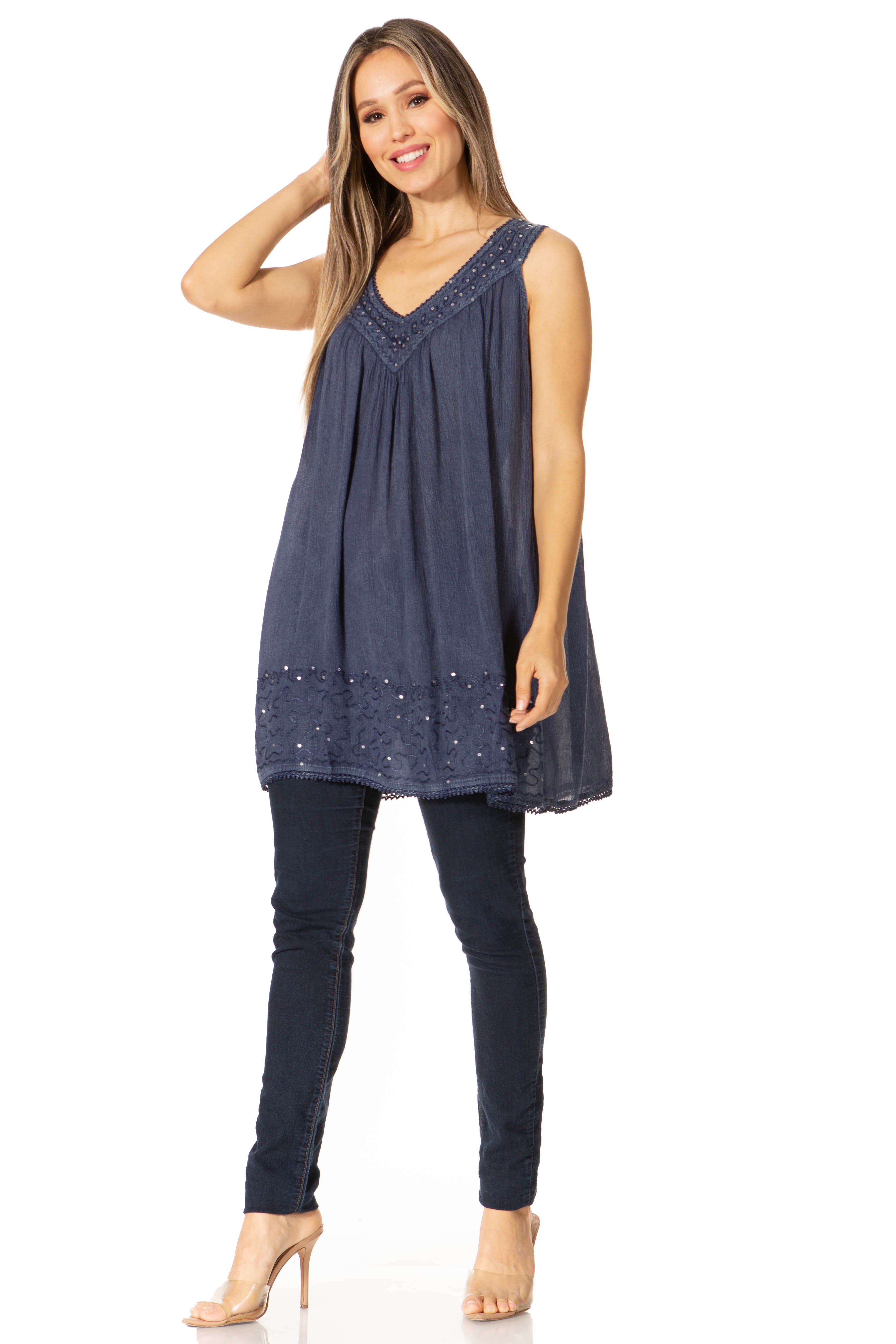 Woman wearing a navy blue sleeveless top and leggings on a white background
