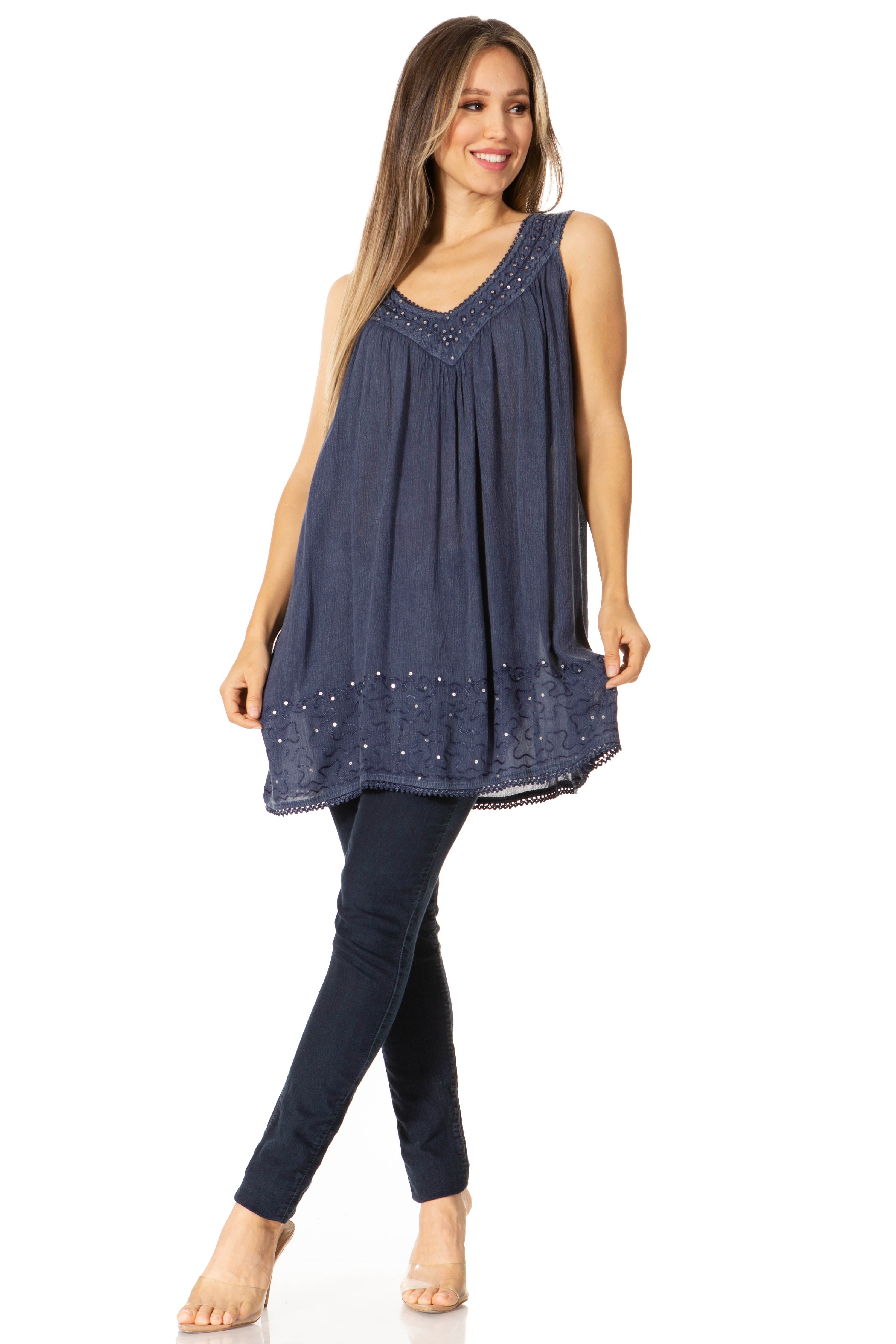 Woman wearing a navy blue sleeveless top and leggings on a white background