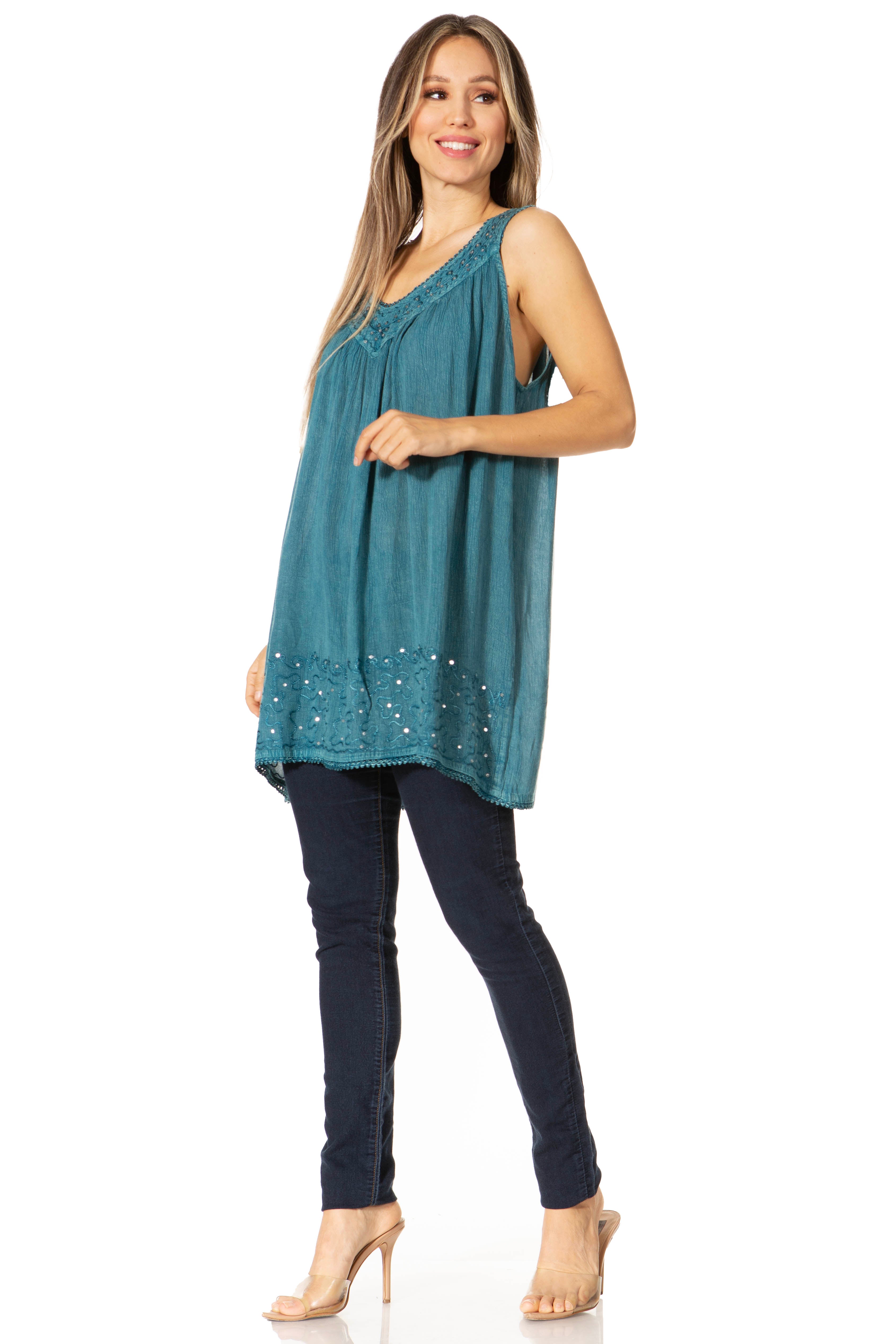Woman wearing a teal sleeveless top with a white background