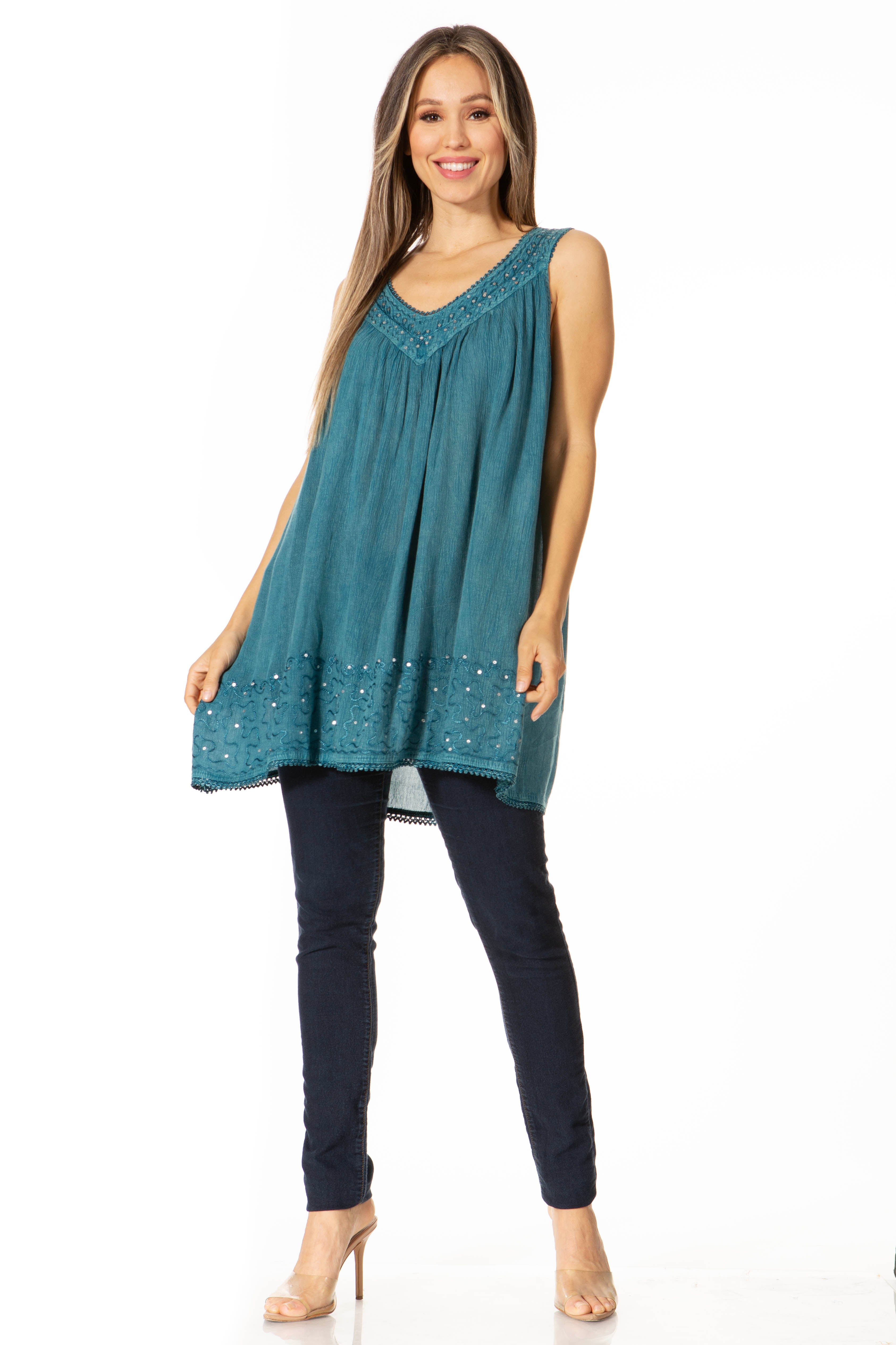Woman wearing a teal sleeveless top with a white background