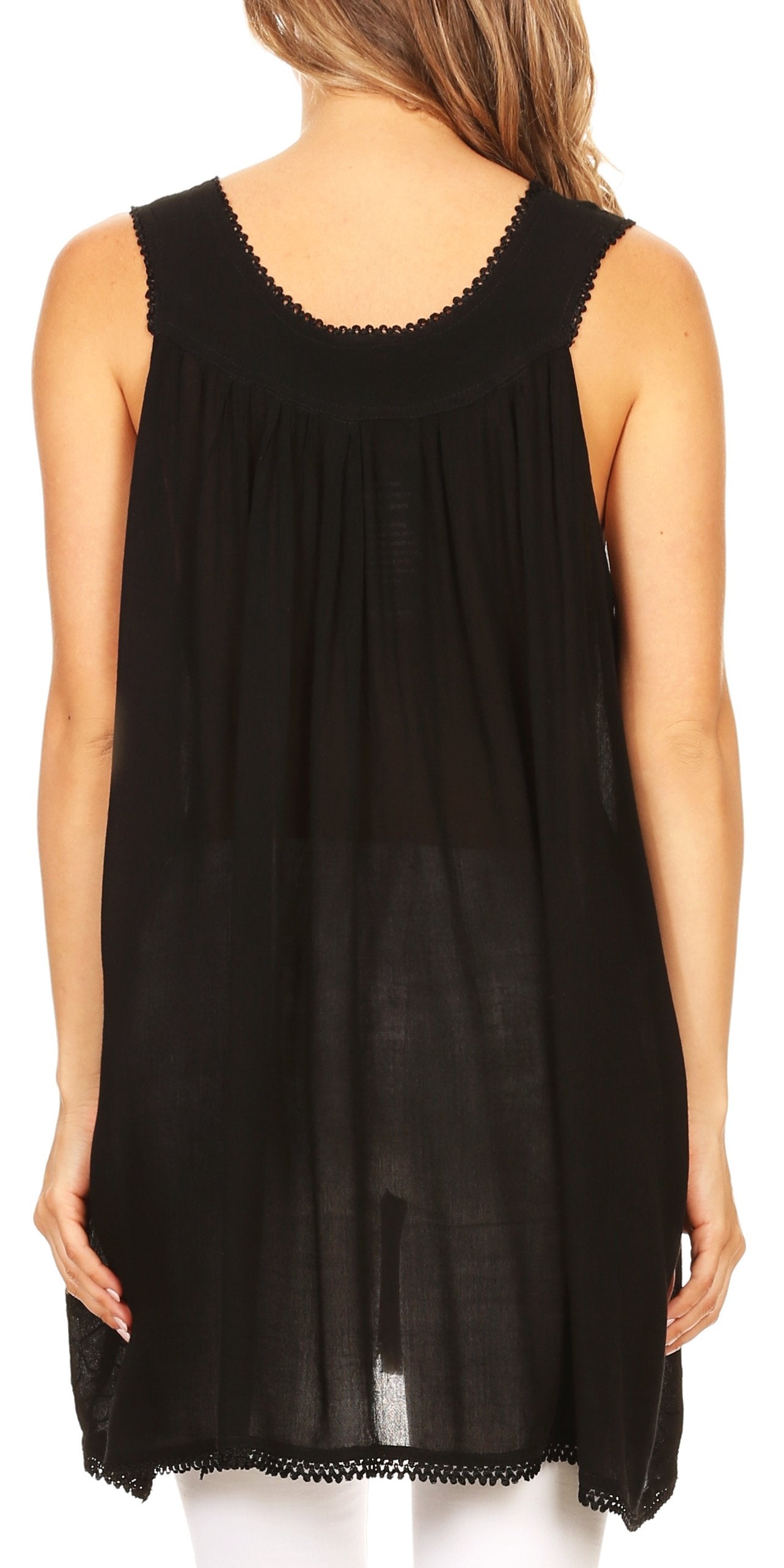 Black sleeveless top worn by a person on a white background