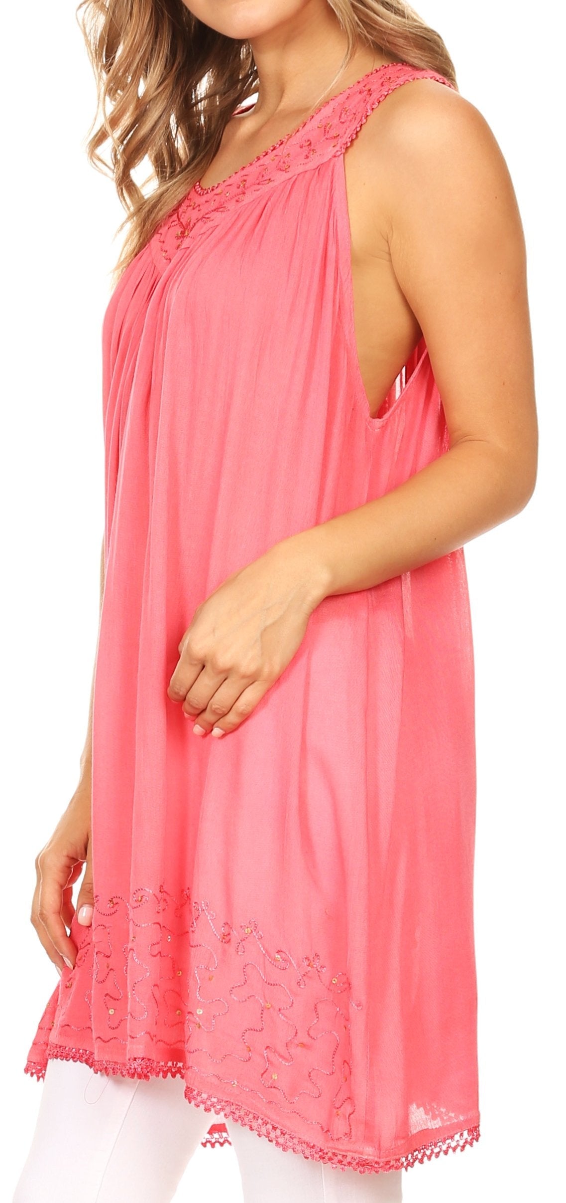 Woman wearing a pink sleeveless top with lace details on a white background