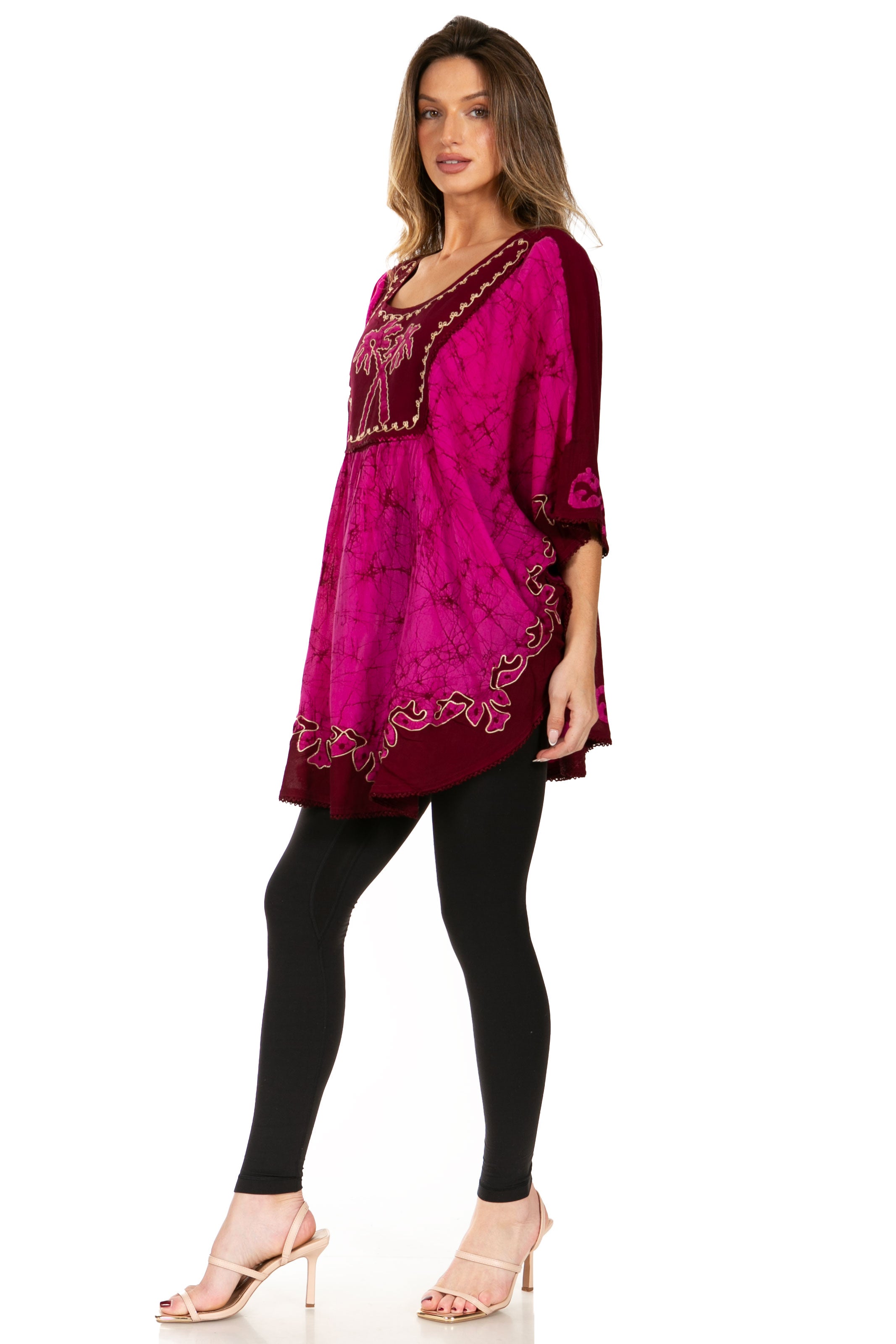 Woman wearing a pink embroidered dress on a white background