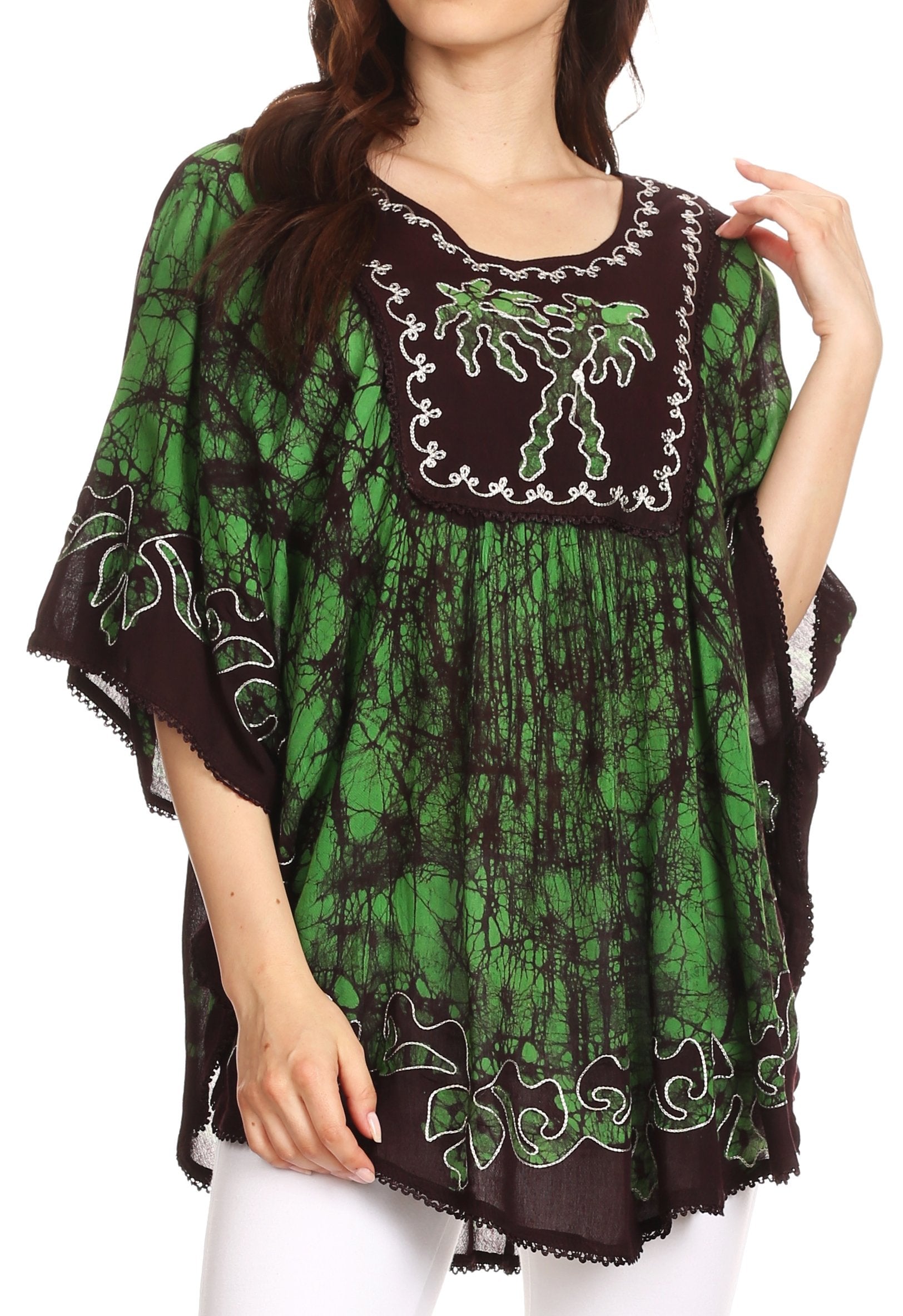 Green and black embroidered dress worn by a model on a white background