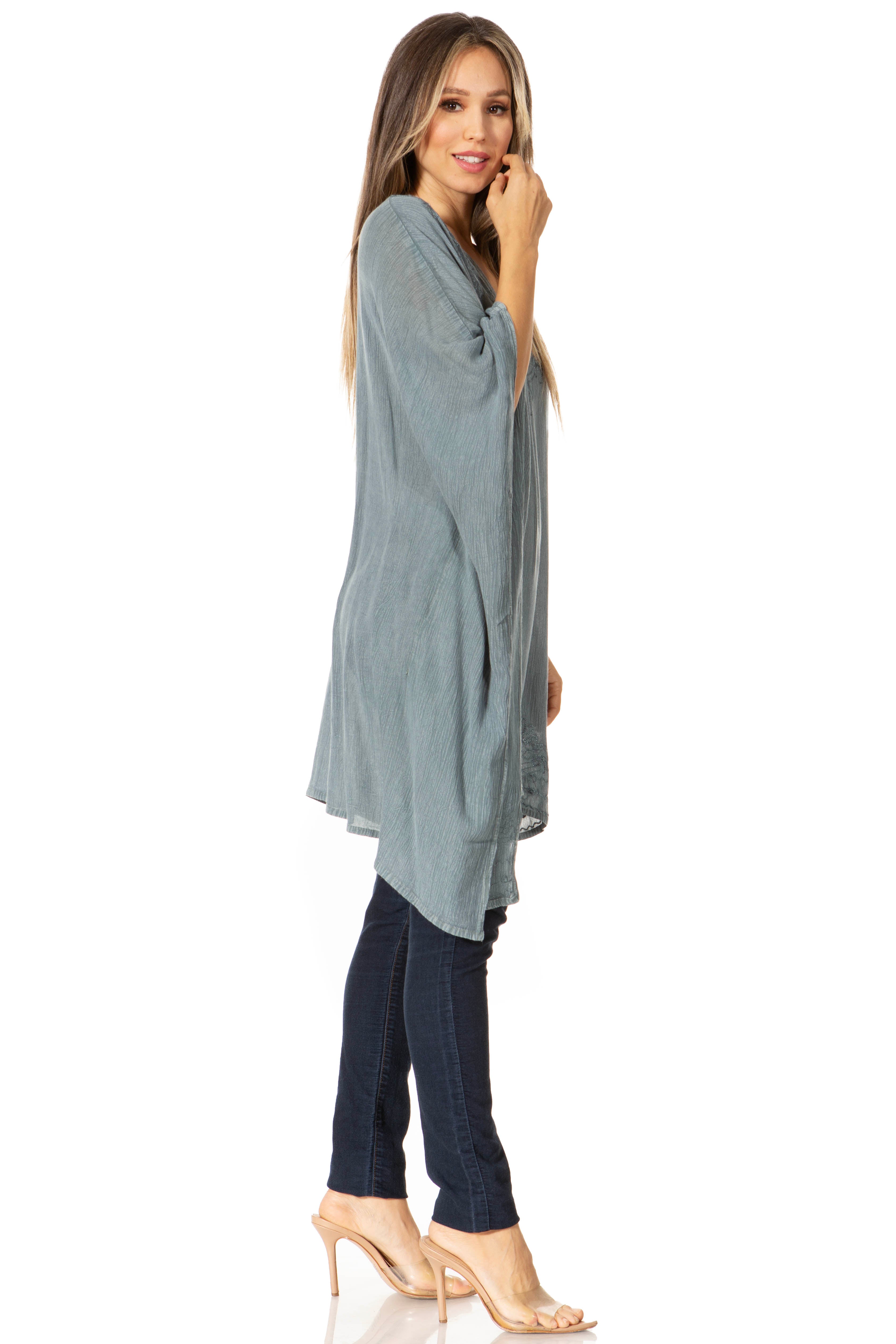 Woman wearing a long, light blue dress with a white background