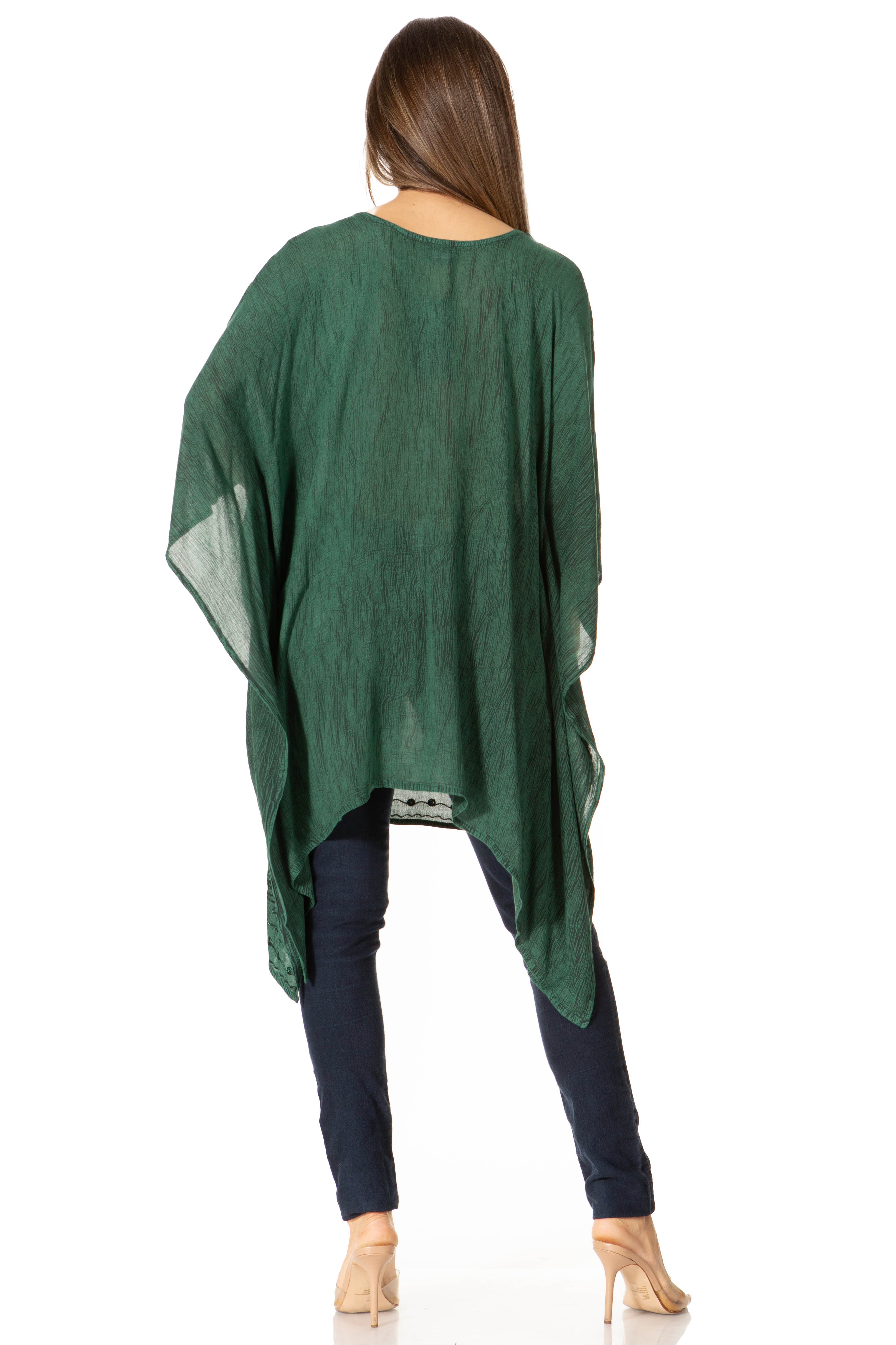 Green poncho worn by a person on a white background