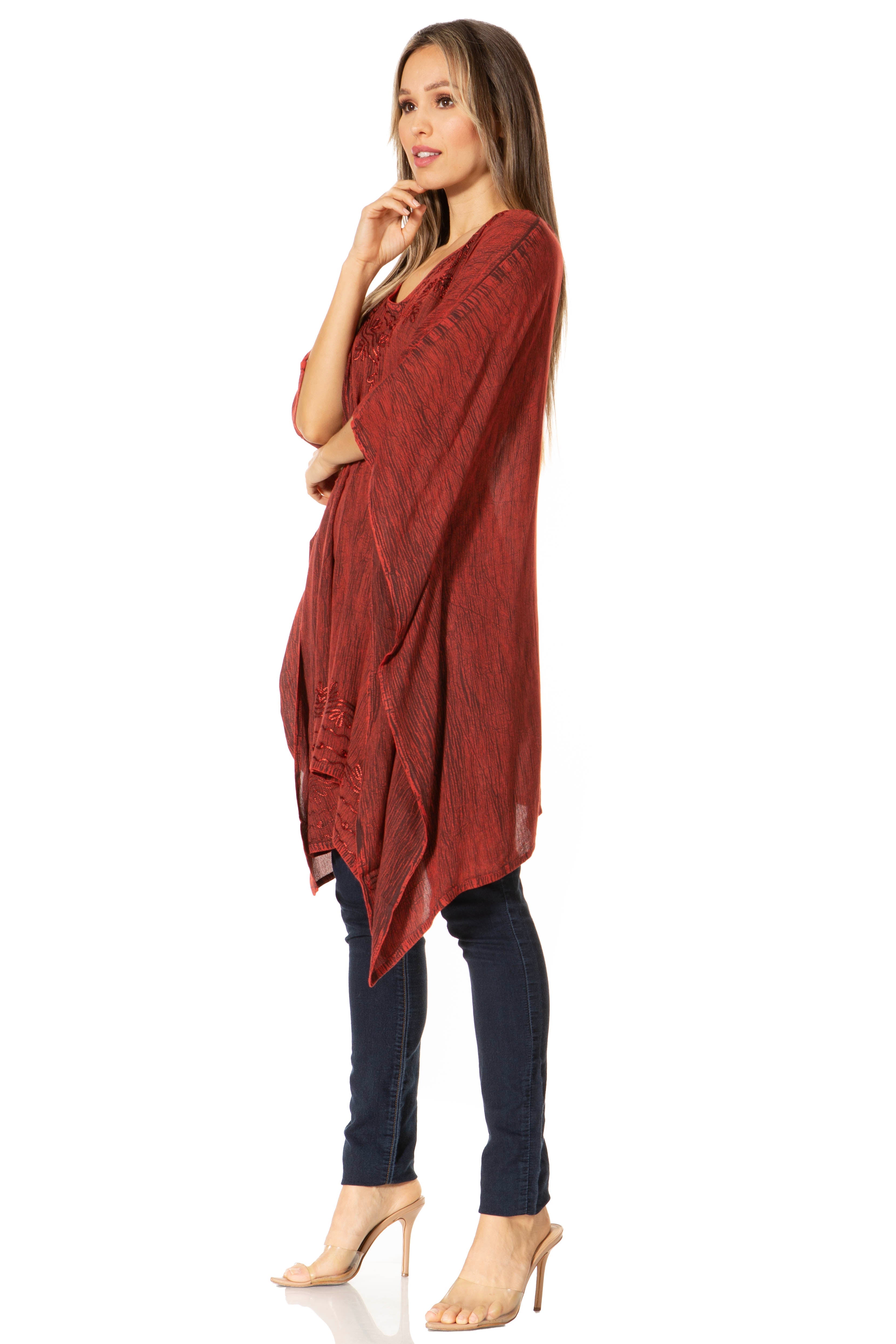 Woman wearing a rust-colored long top with a white background