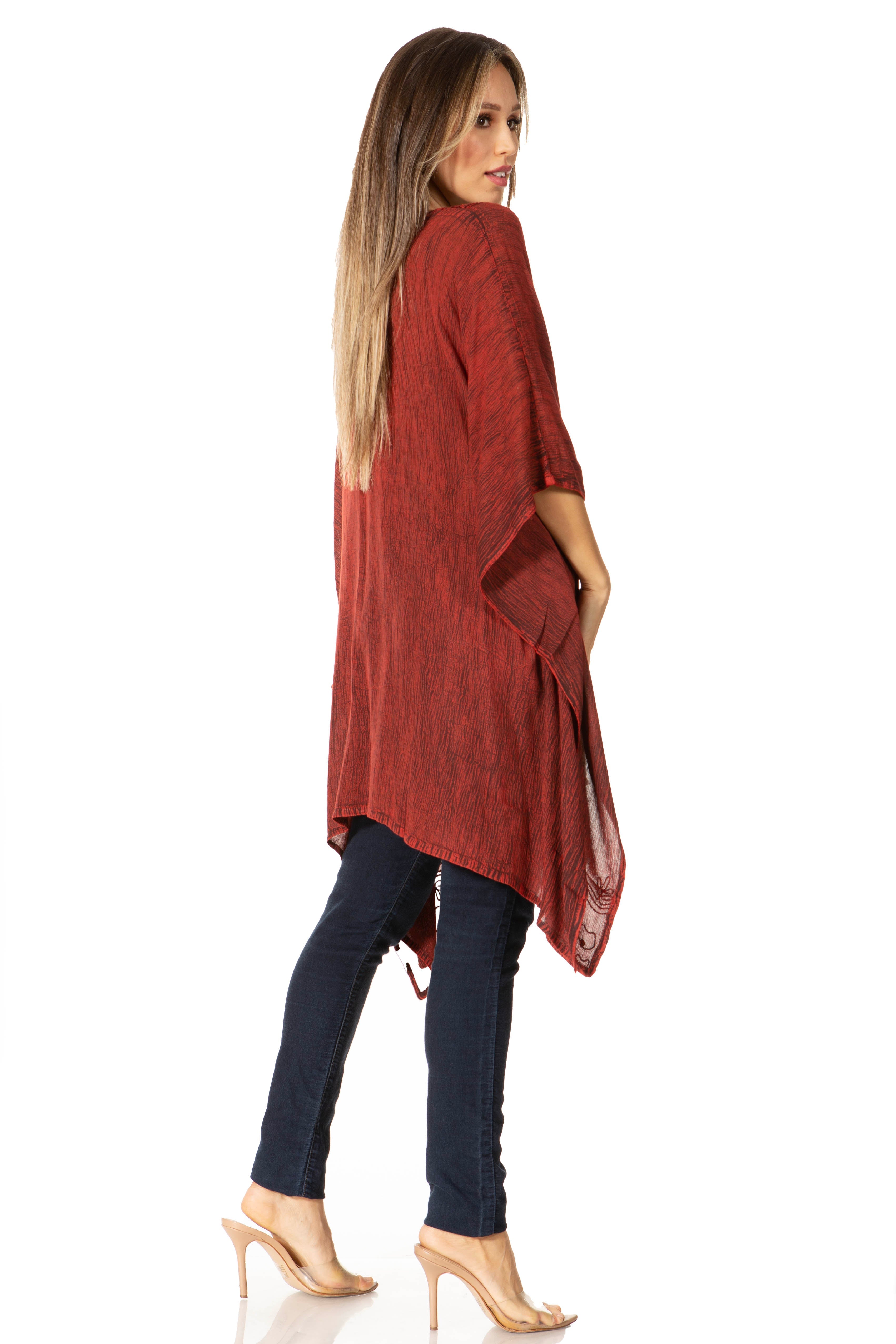 Woman wearing a red kimono-style garment over a dark blue outfit on a white background