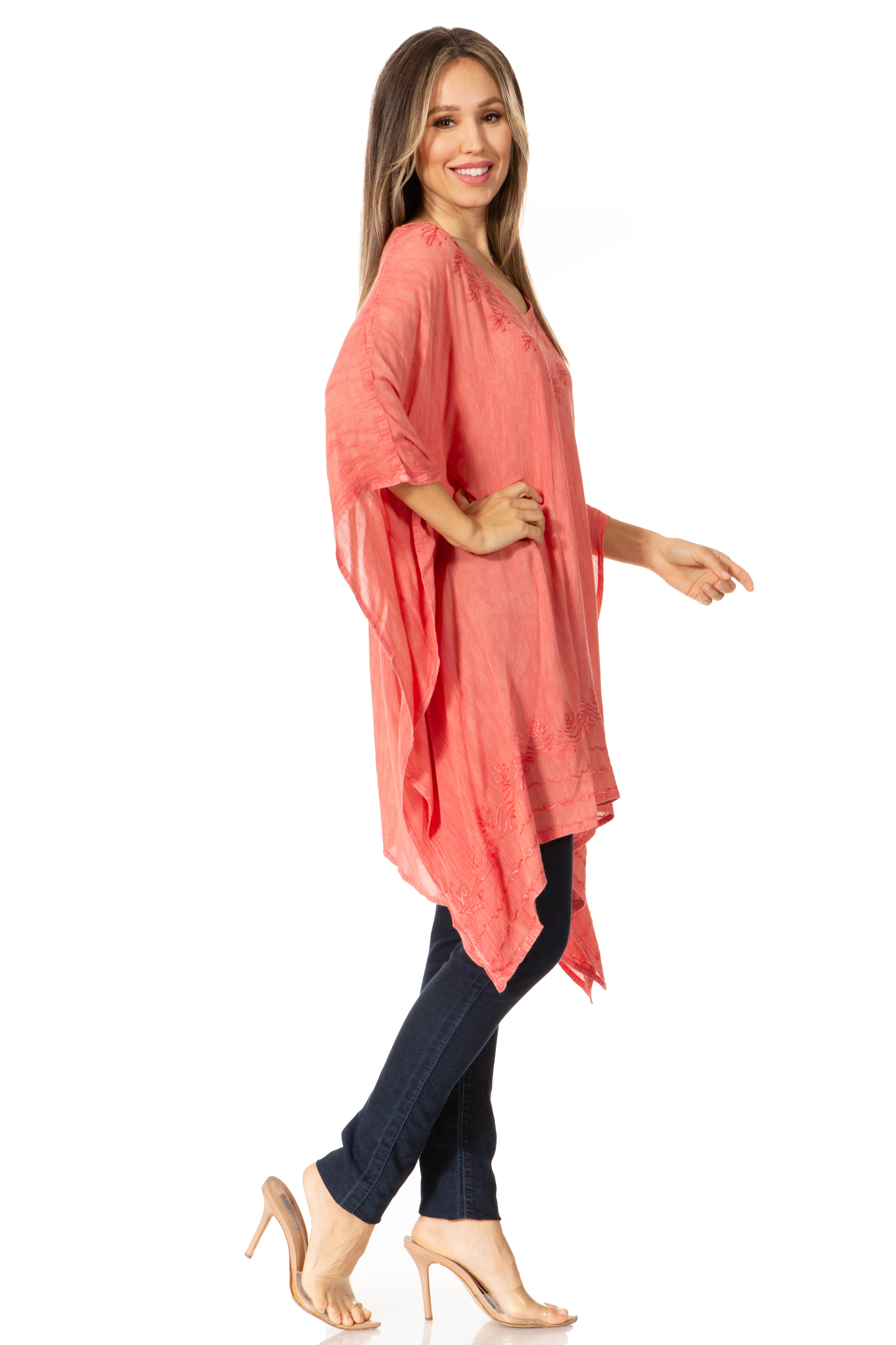 Woman wearing a coral kimono-style garment on a white background