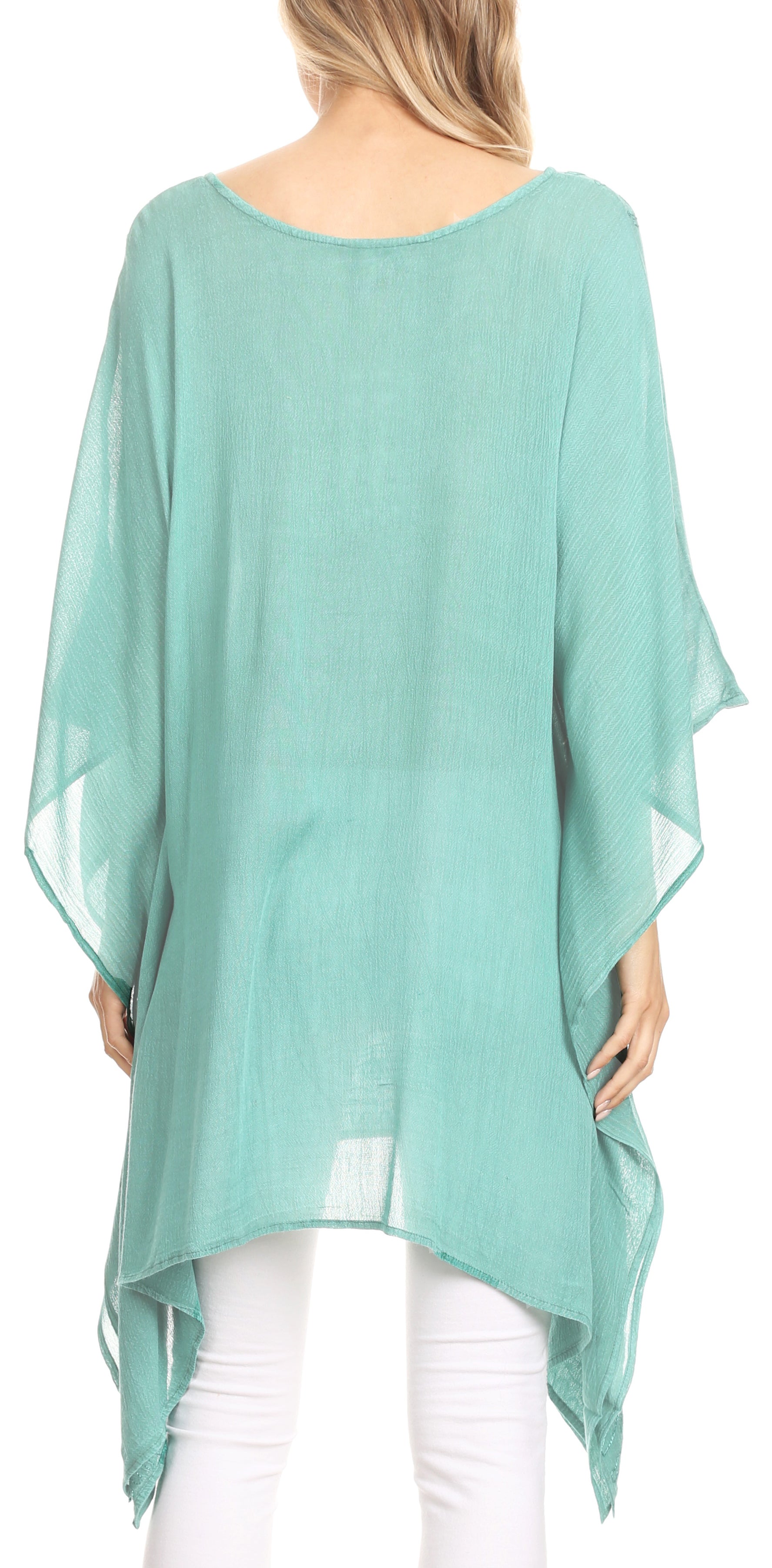 Mint green poncho worn by a person on a white background