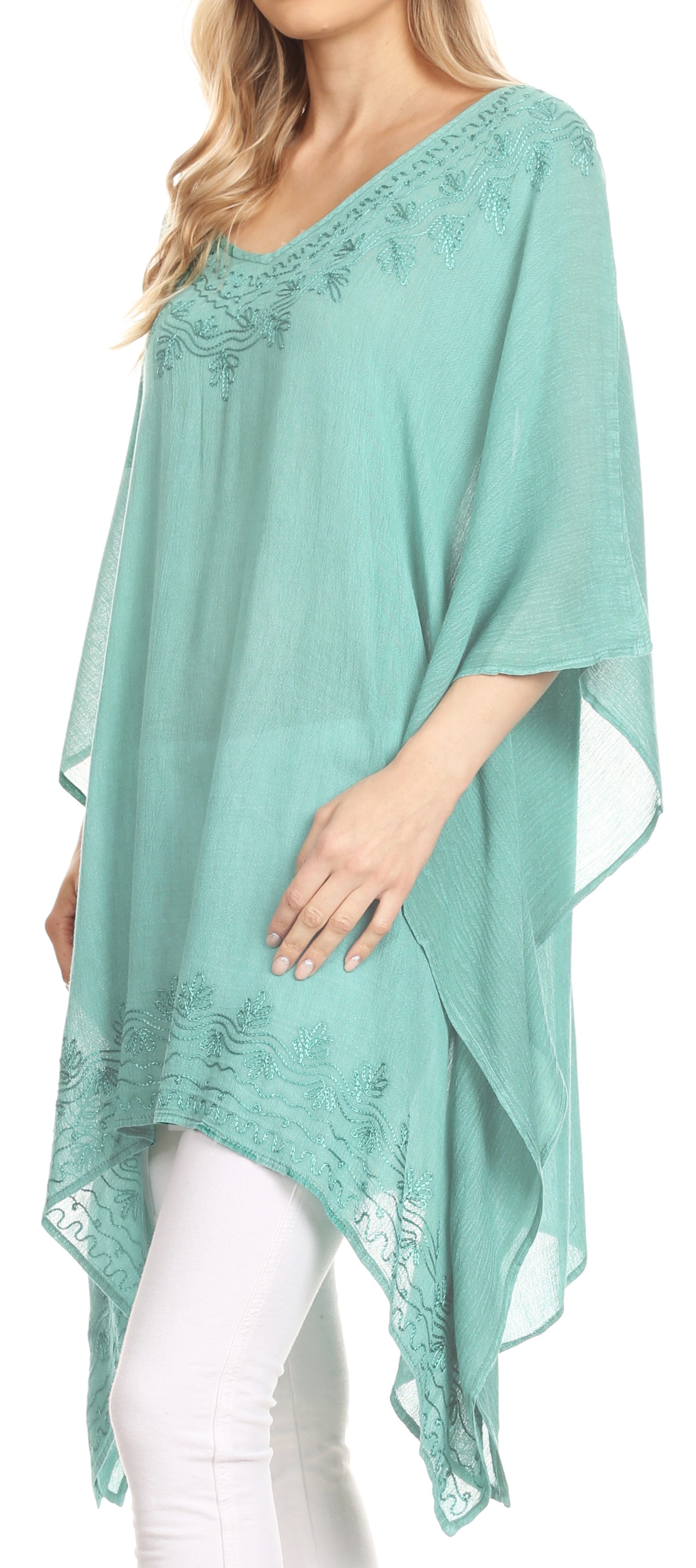 Mint green lace poncho worn by a model on a white background