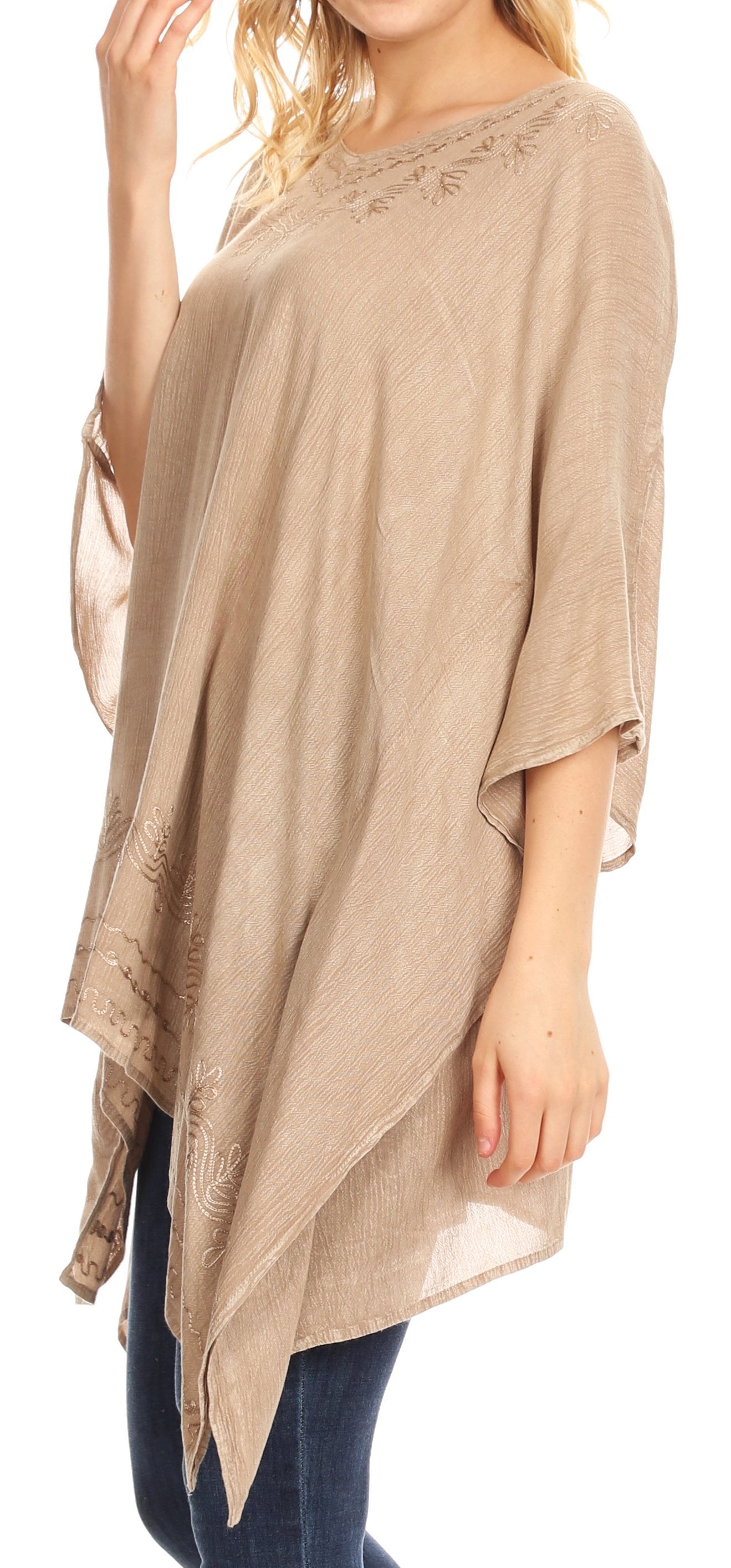 Beige poncho worn by a person on a white background
