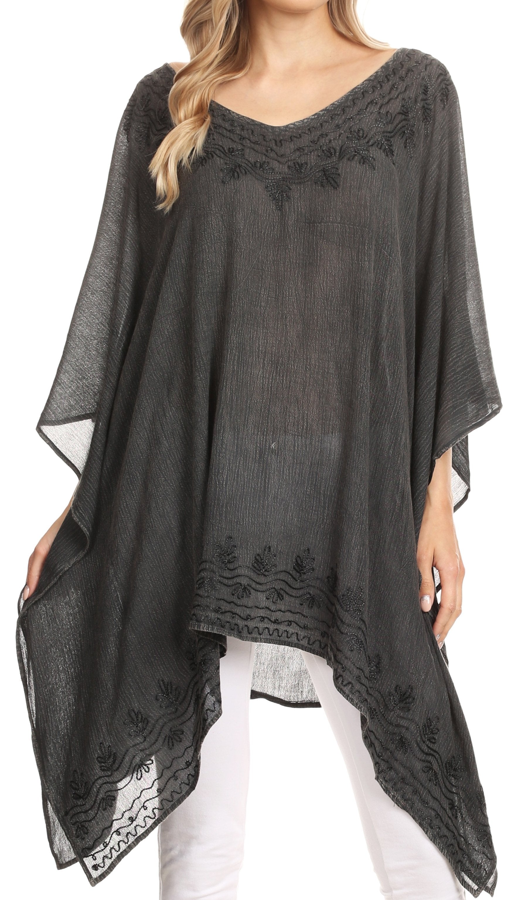 Black lace poncho worn by a model on a white background