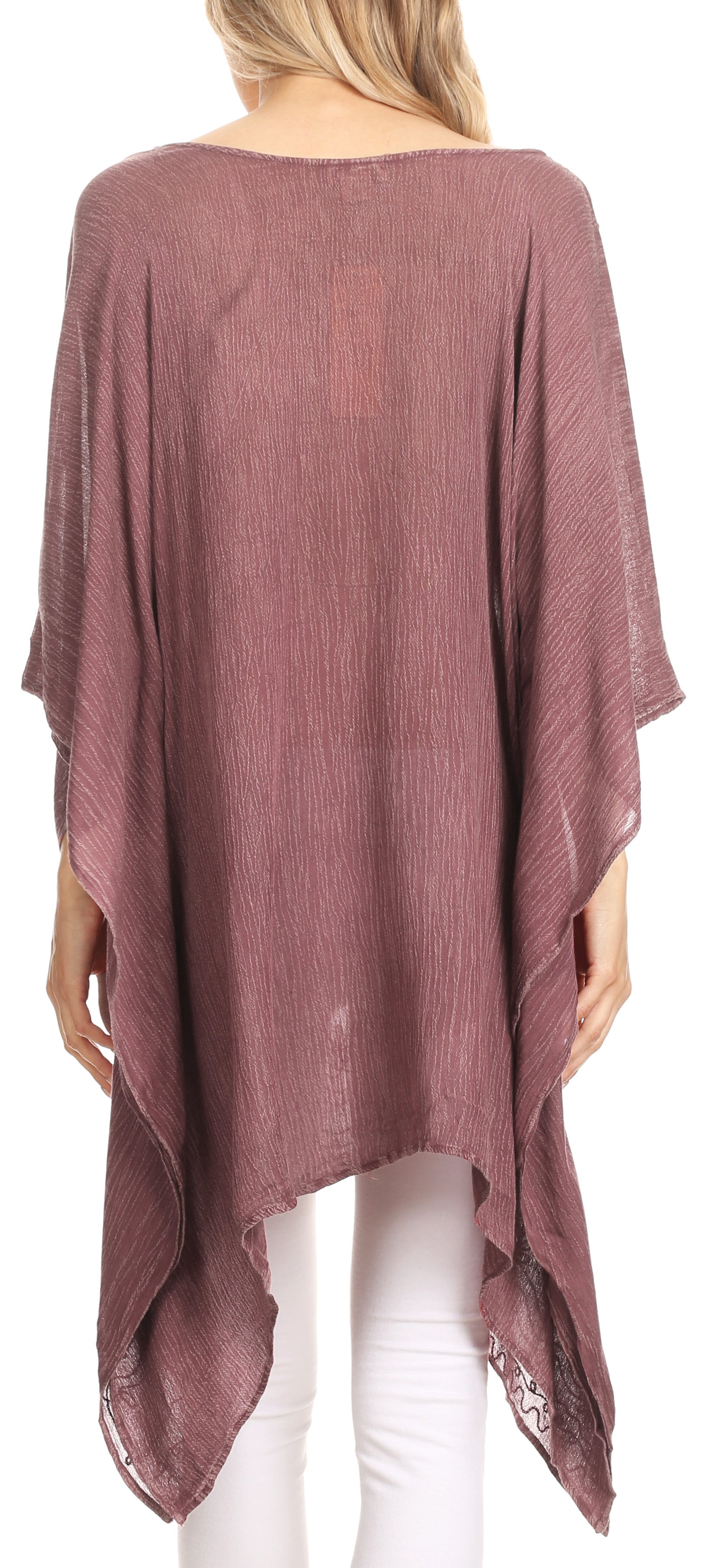 Mauve poncho worn by a person on a white background
