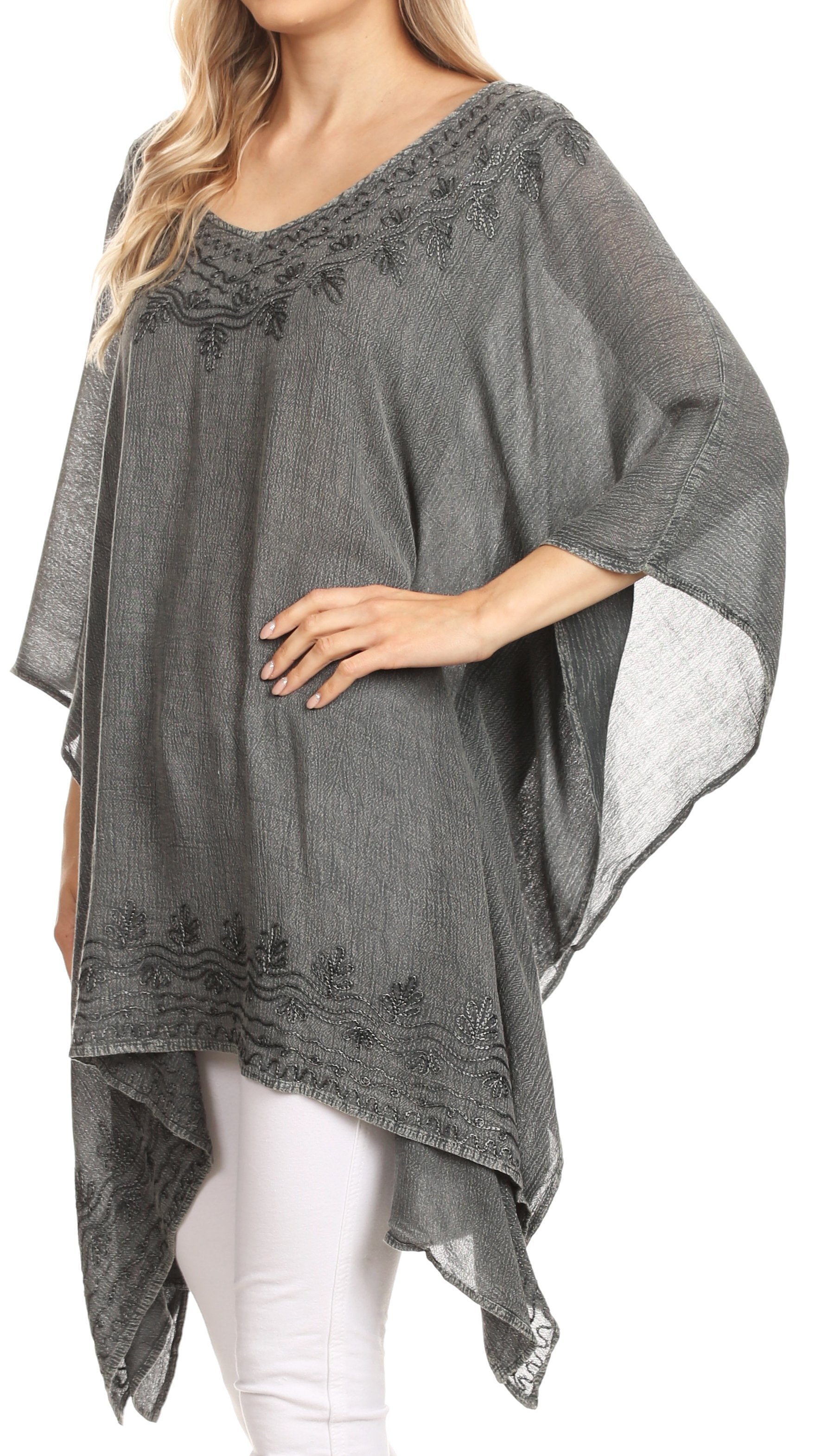 Gray poncho with lace details worn by a model on a white background