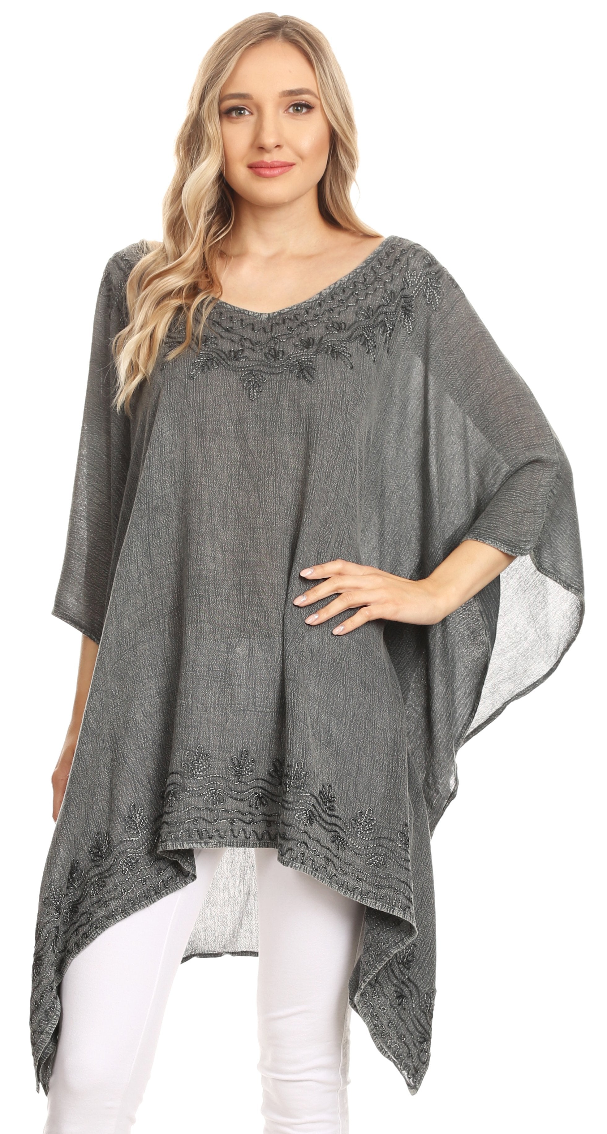 Woman wearing a gray poncho with lace details on a white background