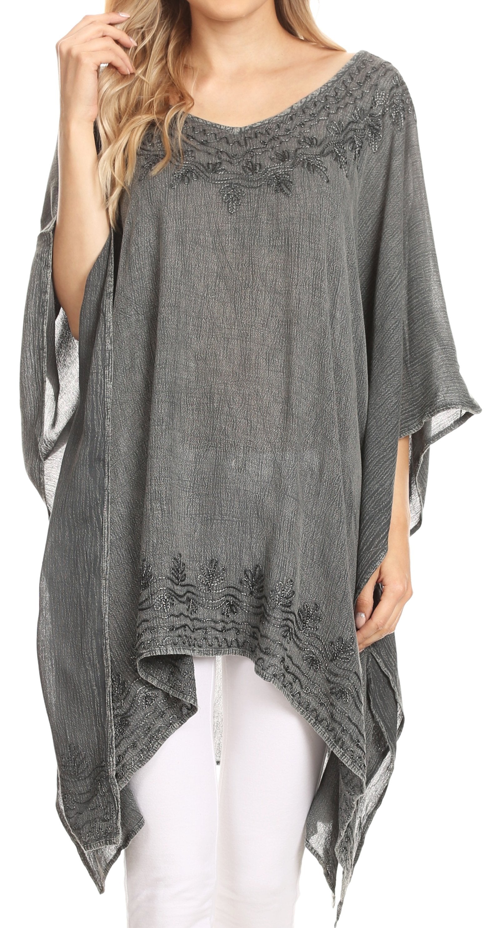 Gray poncho with lace details worn by a model on a white background