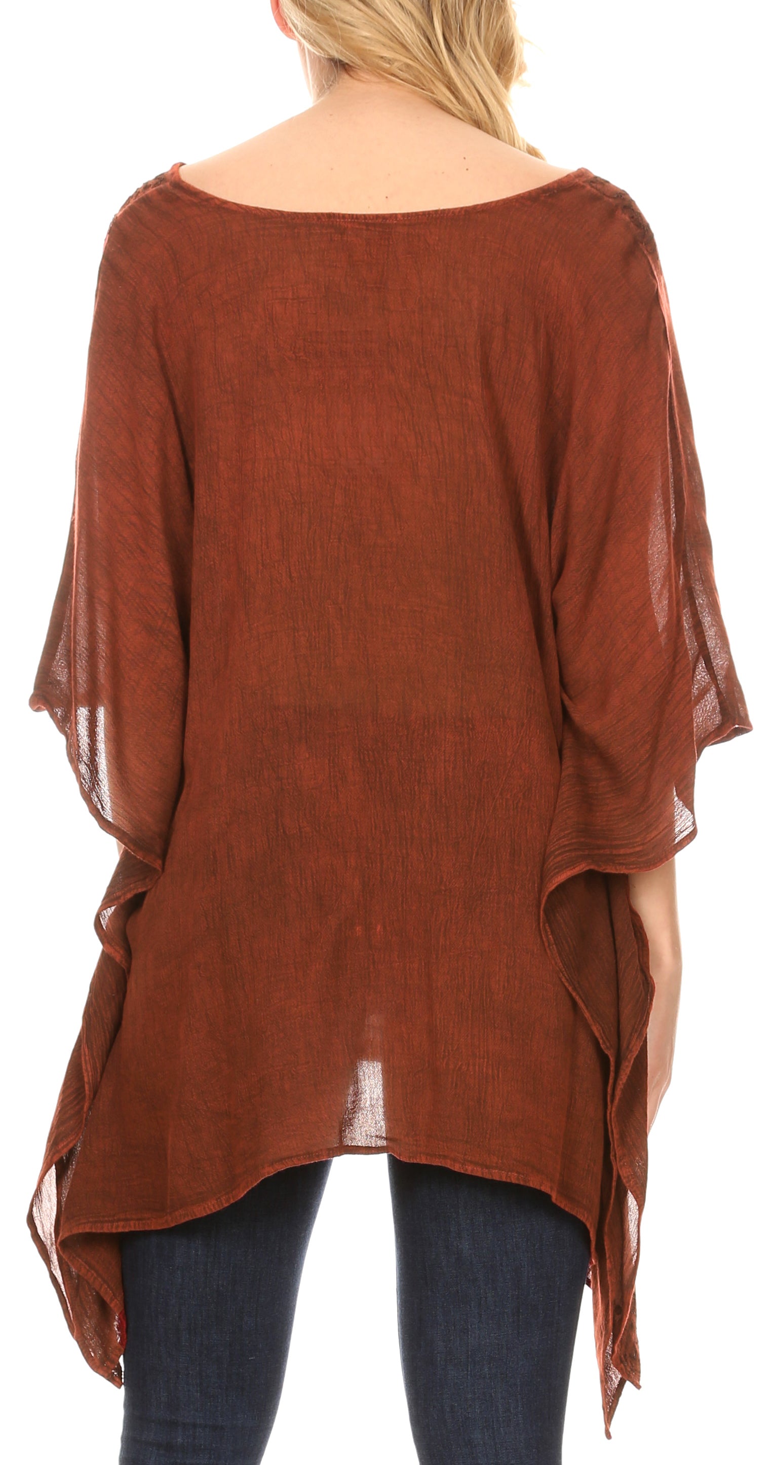 Brown poncho with fringe details over a white background