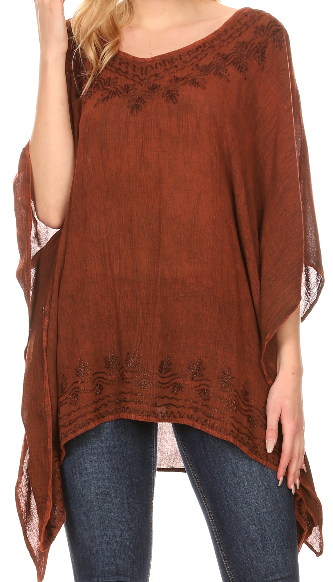 Brown poncho with lace details worn by a person, on a white background