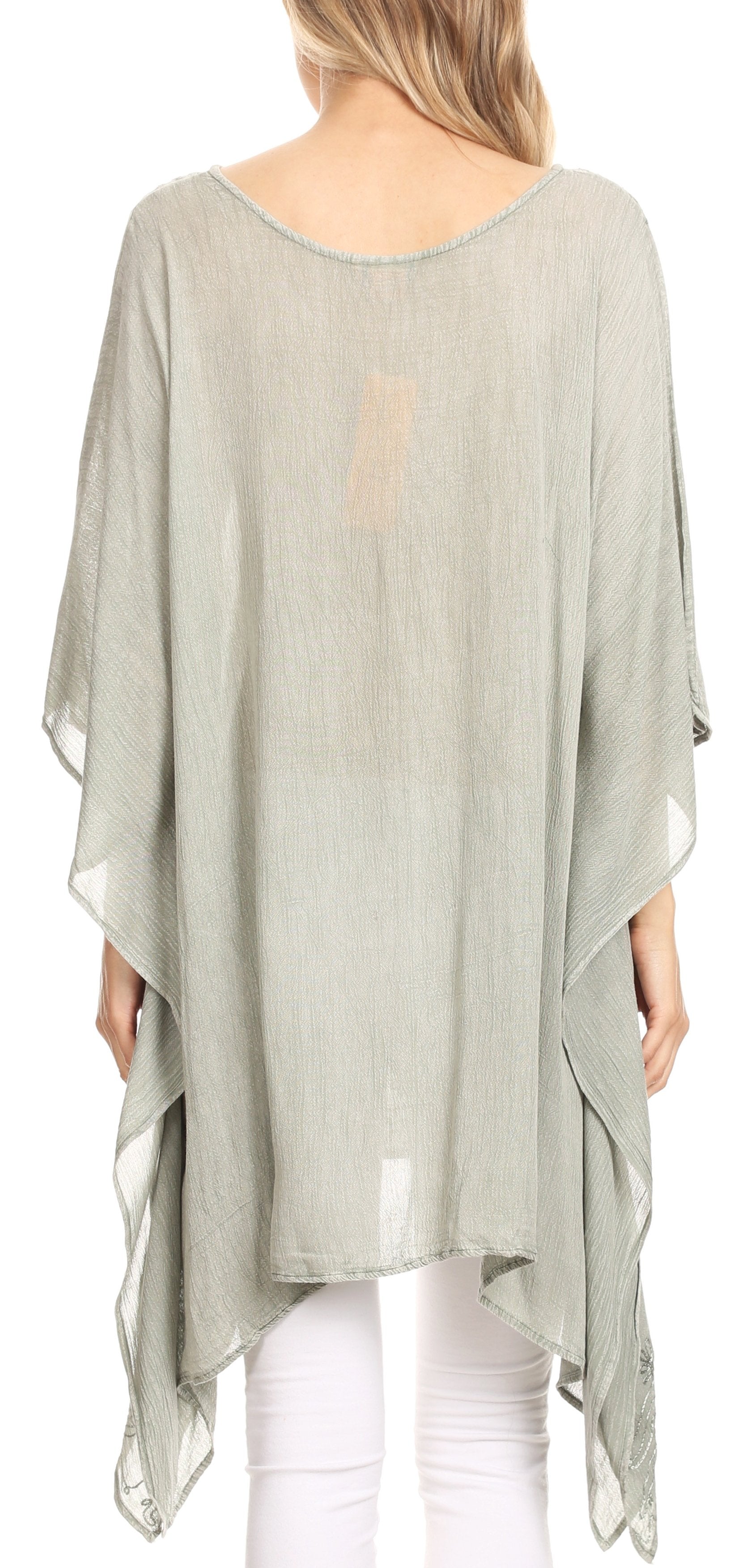 Light gray poncho with sheer back panels worn by a person on a white background