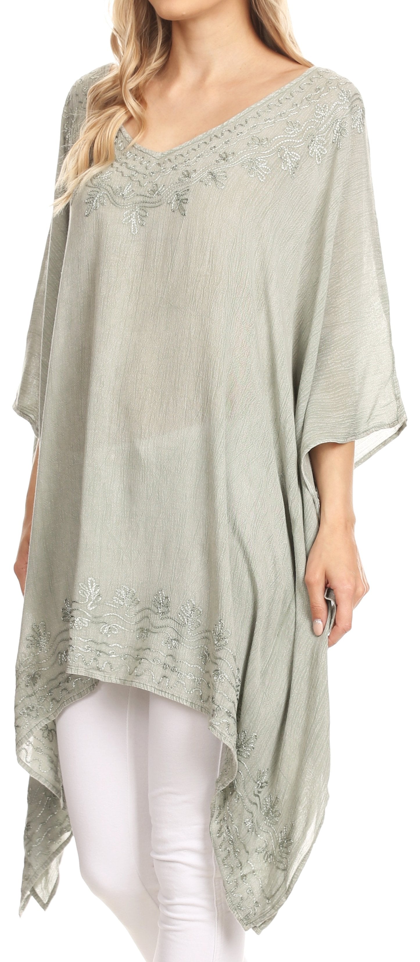 Woman wearing a light green lace-trimmed dress with a white background
