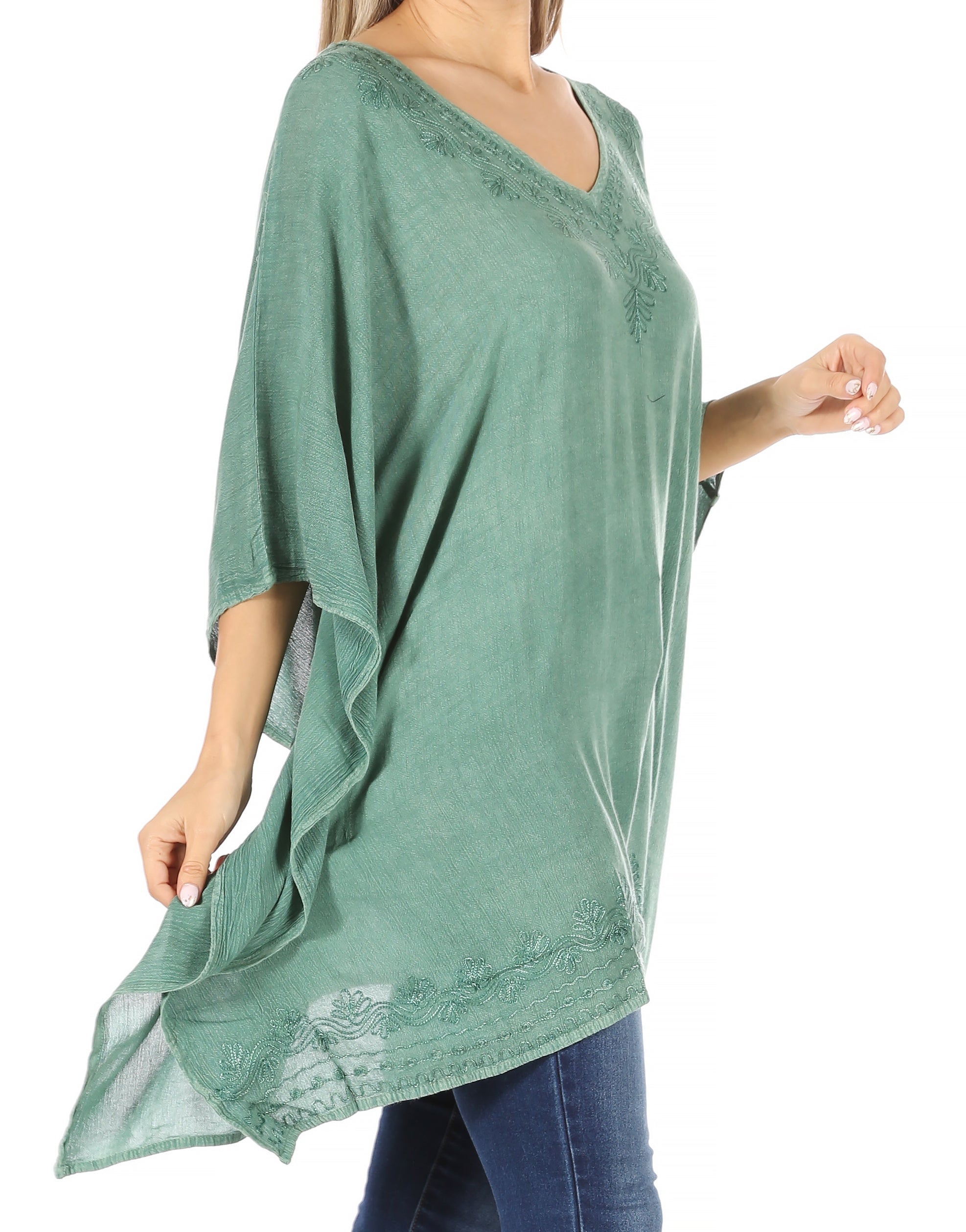 Green oversized tunic with lace details worn by a person on a white background