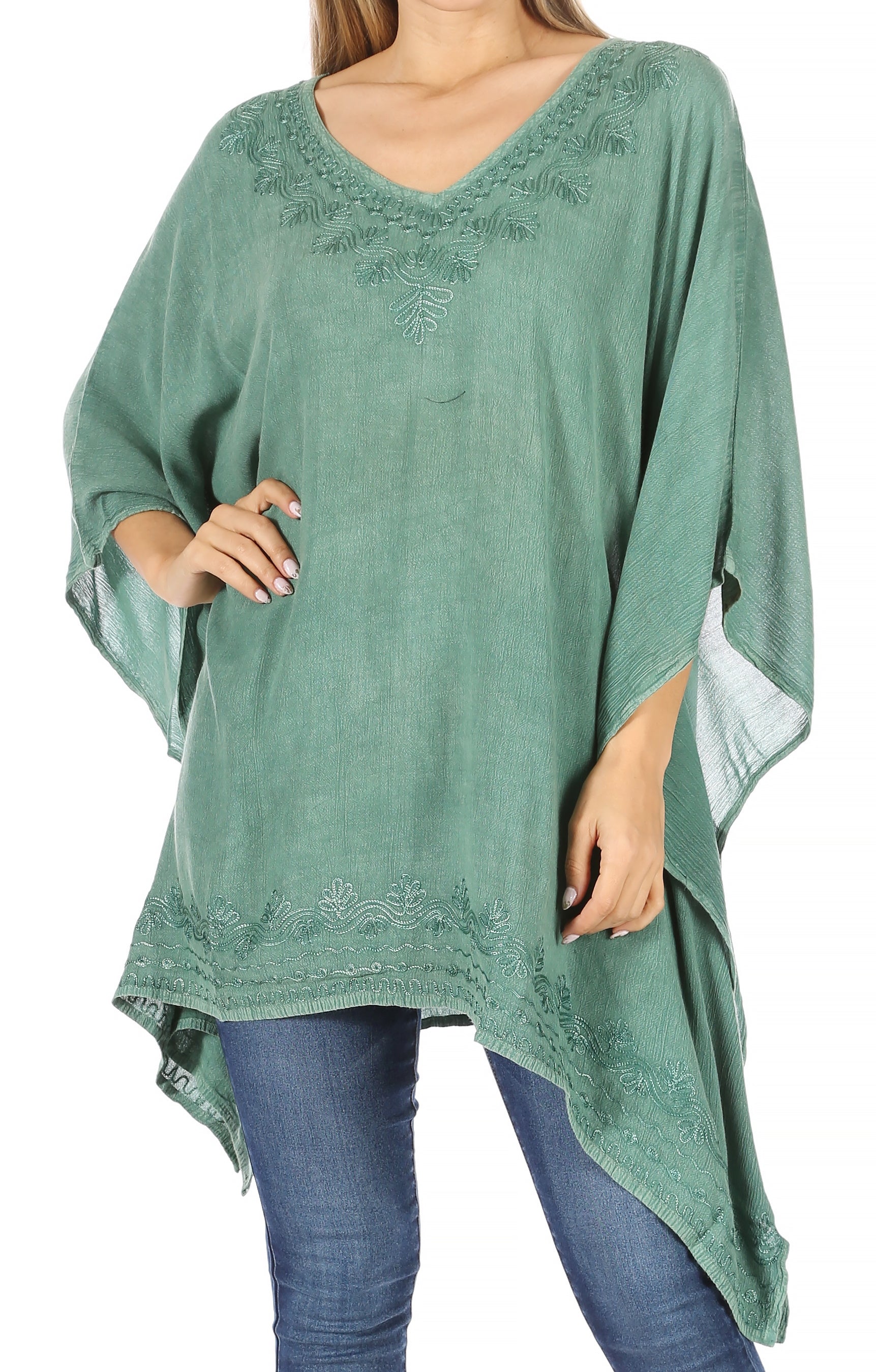 Green embroidered top worn by a person on a white background