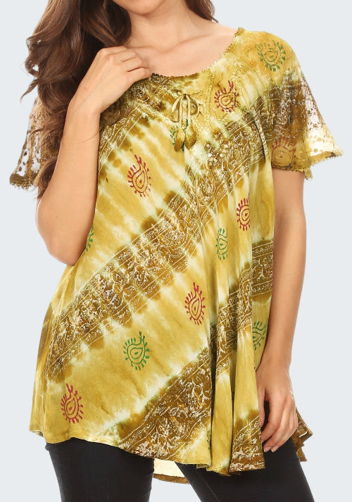 Woman wearing a yellow tie-dye top with intricate patterns on a white background