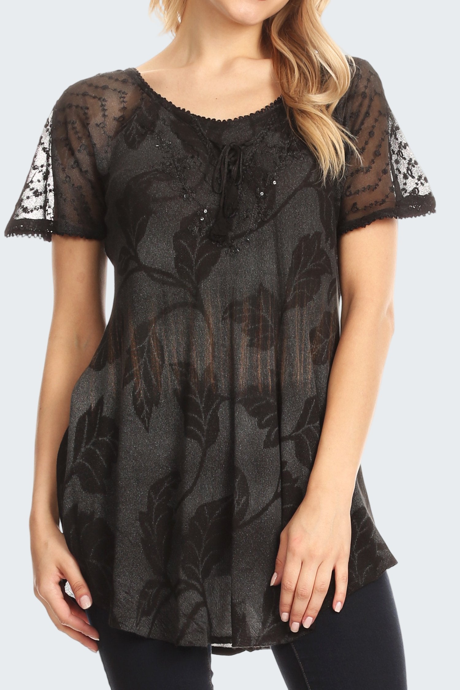 Black lace top worn by a model on a white background