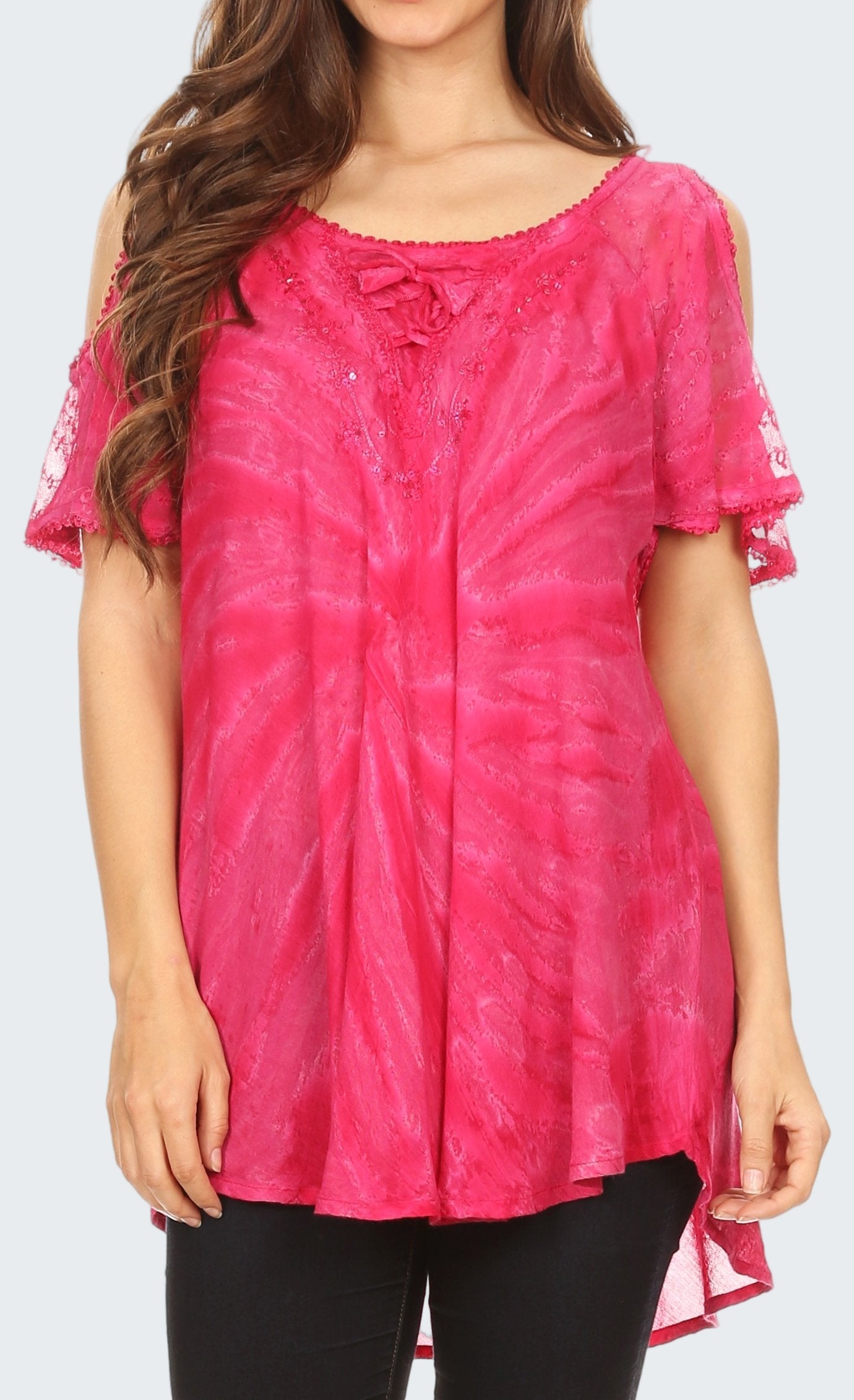 Woman wearing a pink tie-dye top with a plain background