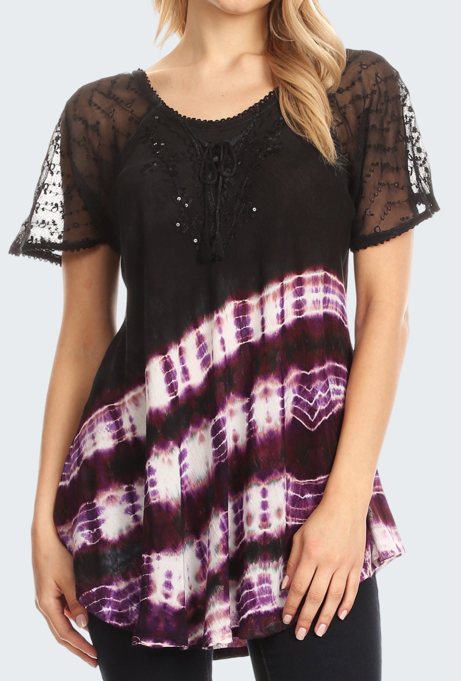 Black lace top with tie-dye pattern worn by a model