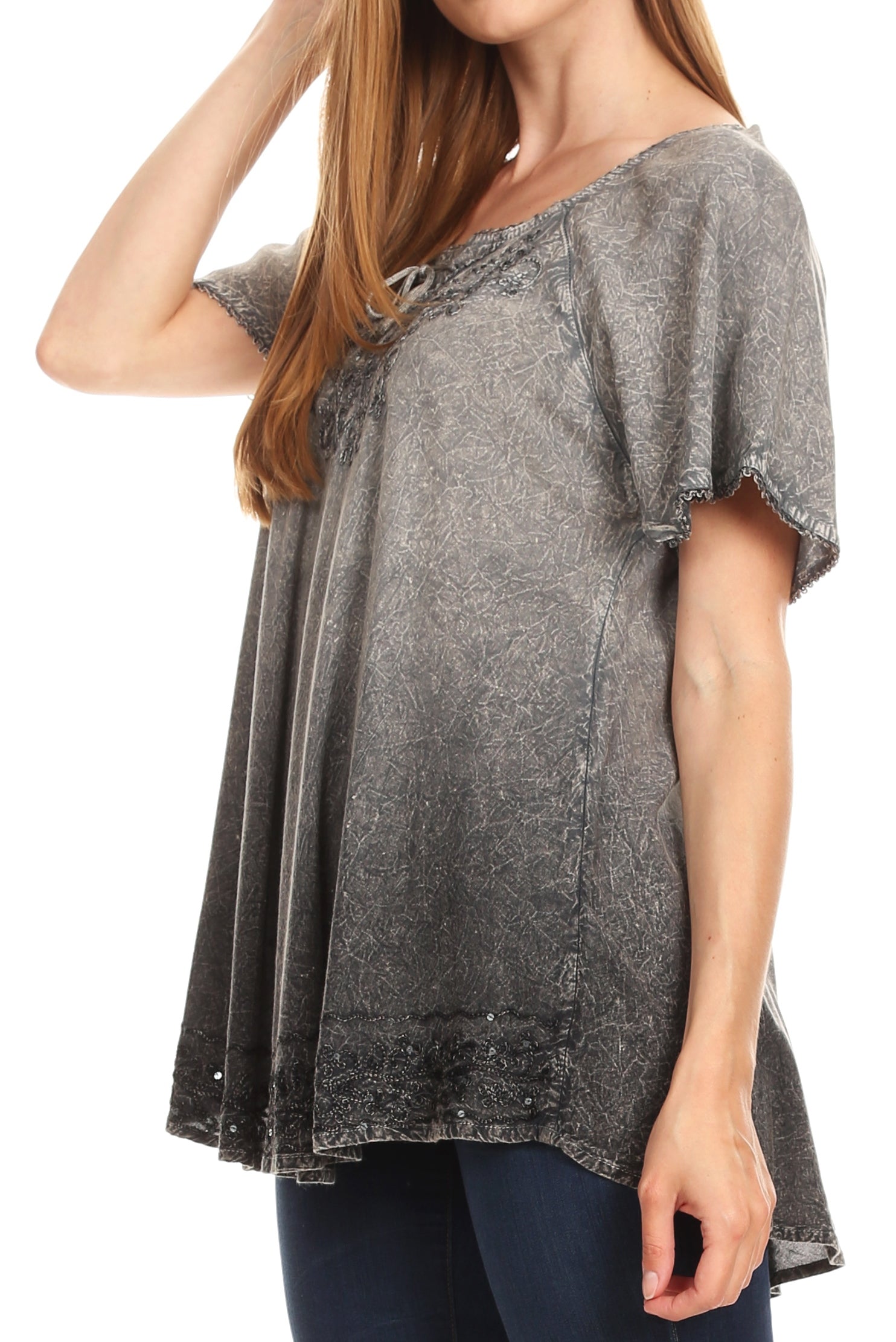 Woman wearing a gray distressed t-shirt on a white background