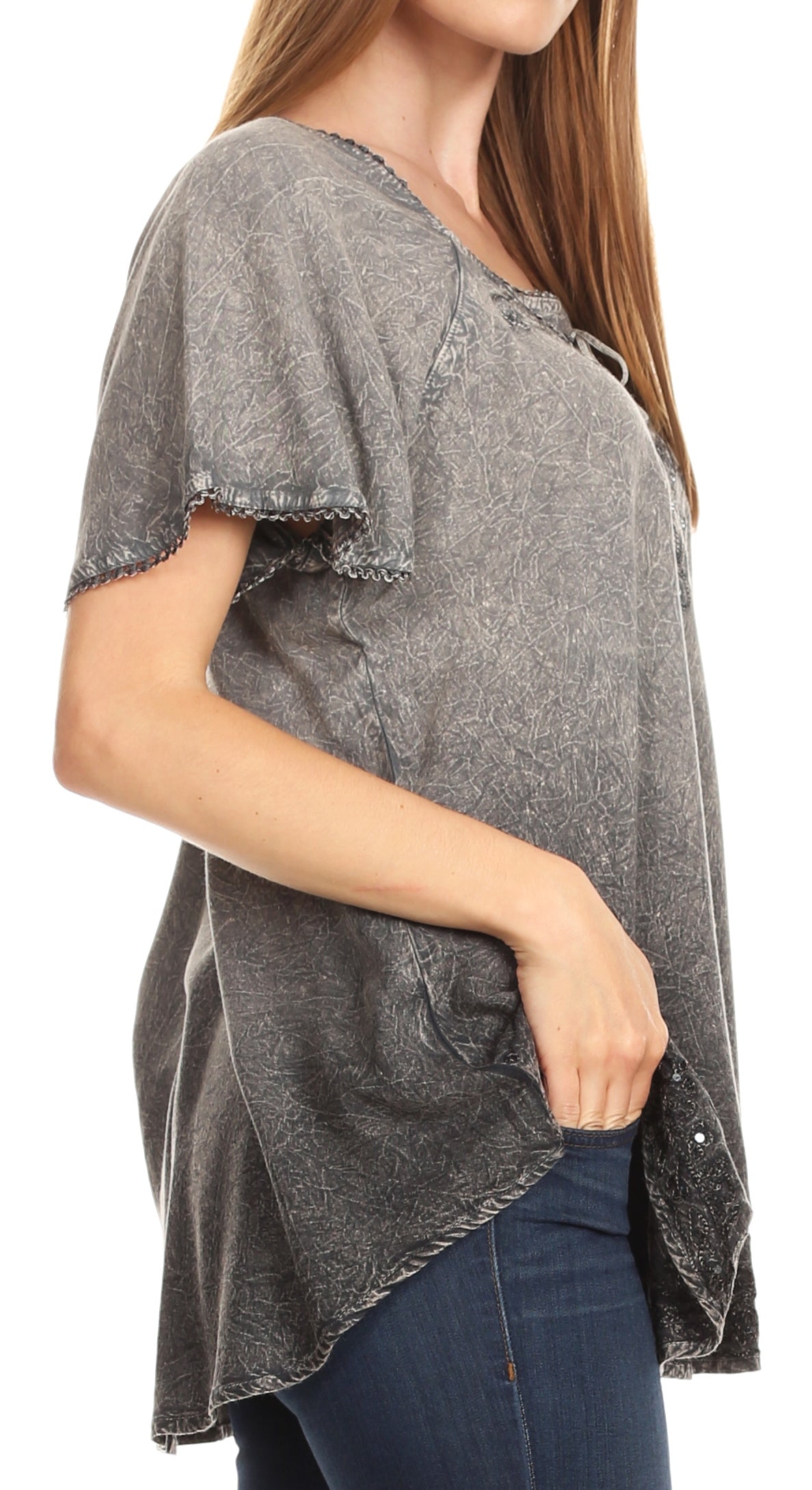 Woman wearing a gray short-sleeve top with a white background