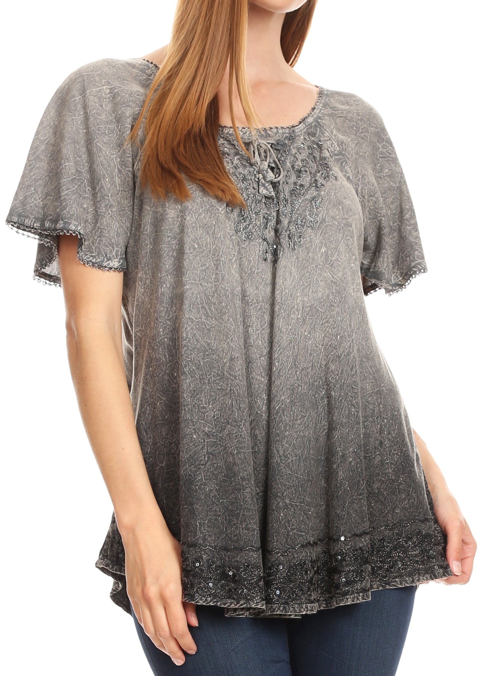 Woman wearing a gray lace top with a white background