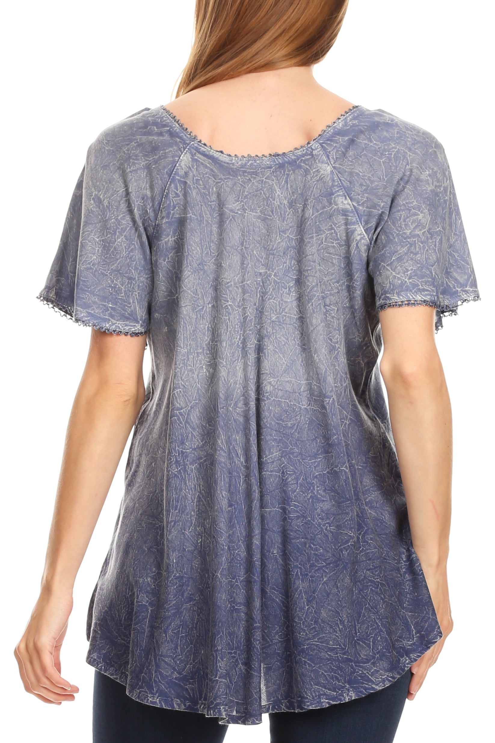Blue patterned tunic worn by a person on a white background