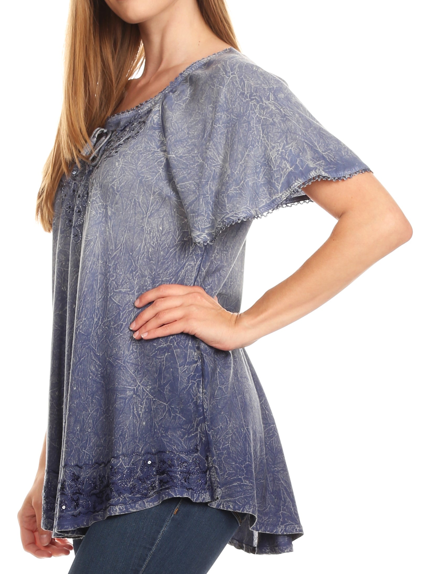 Woman wearing a blue denim-style top with a white background